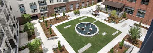 Aerial daytime view of the AMLI Decatur grassy and landscaped courtyard encircled by the apartment and office buildings