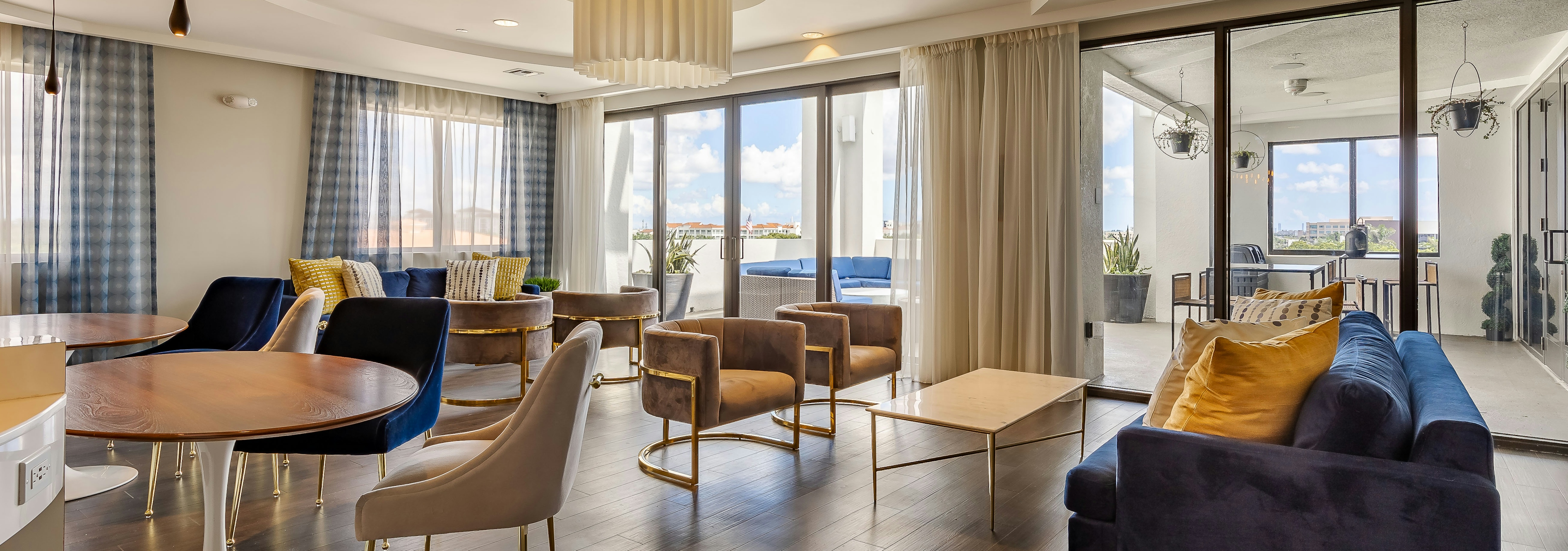 AMLI 8800 apartment resident sky lounge with dark wood floors and contemporary seating with floor to ceiling windows