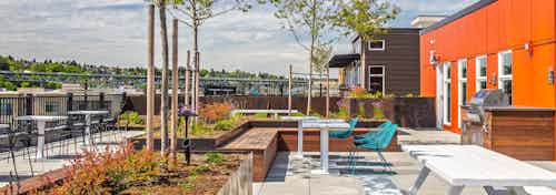 One of three rooftop decks at AMLI Wallingford with BBQ grill and lots of colorful seating to enjoy the Downtown Seattle and Lake Union View
