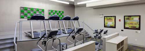 Alternate view of the fitness center at AMLI Evanston apartment community with treadmills and elliptical machines