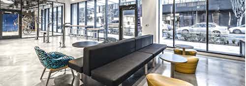 Interior bike lounge of AMLI Arc with seating bike tools bike shower and large windows and access to the street