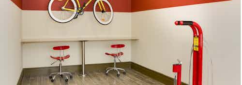 AMLI Ponce Park apartment bike repair room with large table set up for all bike repair needs and air pump for bike tires