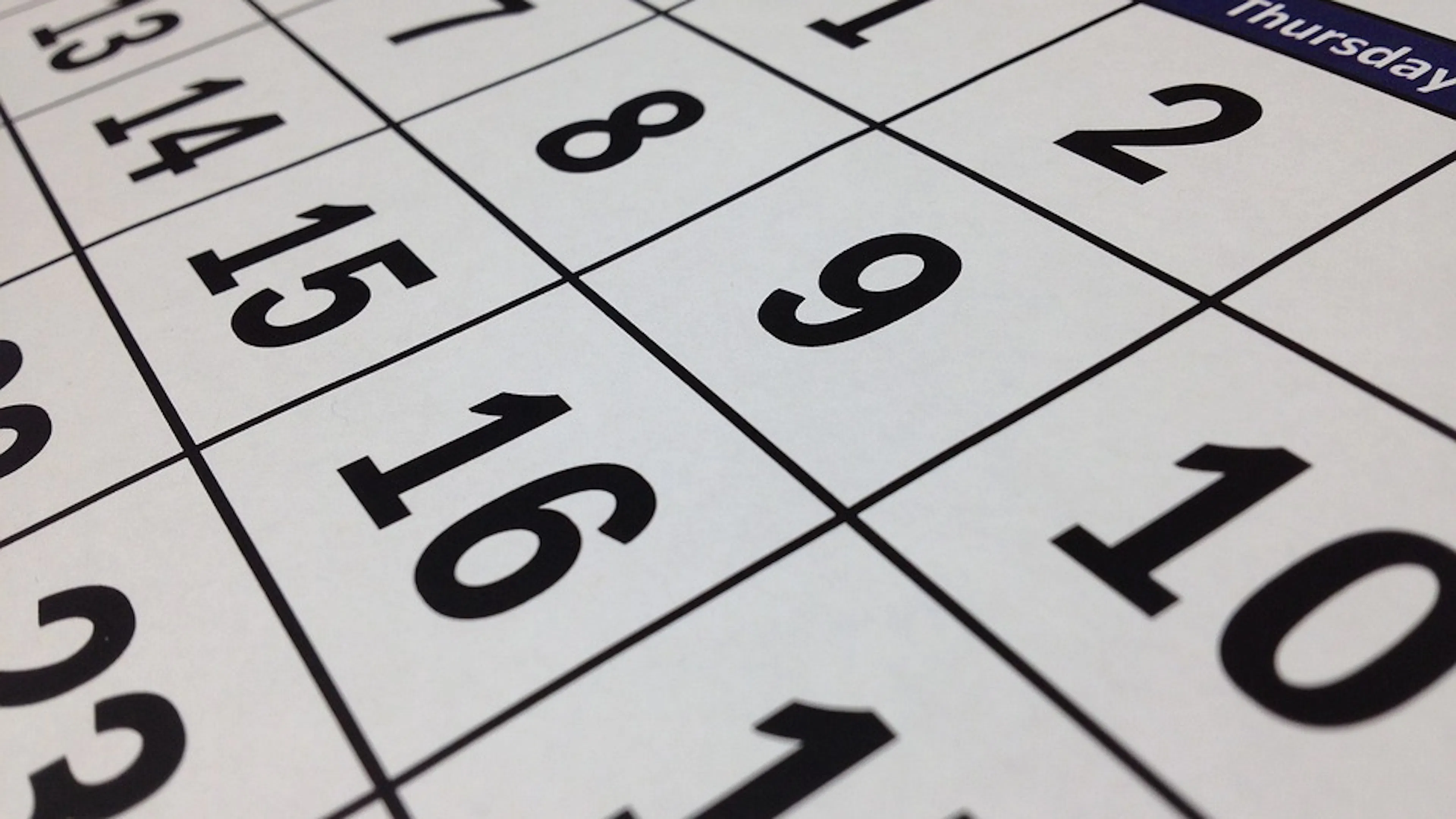 Close up of a calendar with large print numbers on the dates