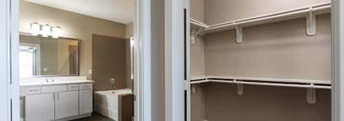 Close up of AMLI Eastside closet with built in shelving and an open door showing bathroom with a light vanity sink and mirror