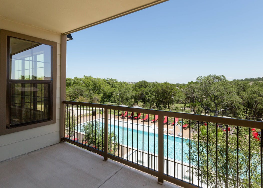 AMLI Covered Bridge spacious balcony overlooking the resident pool and lush green landscape