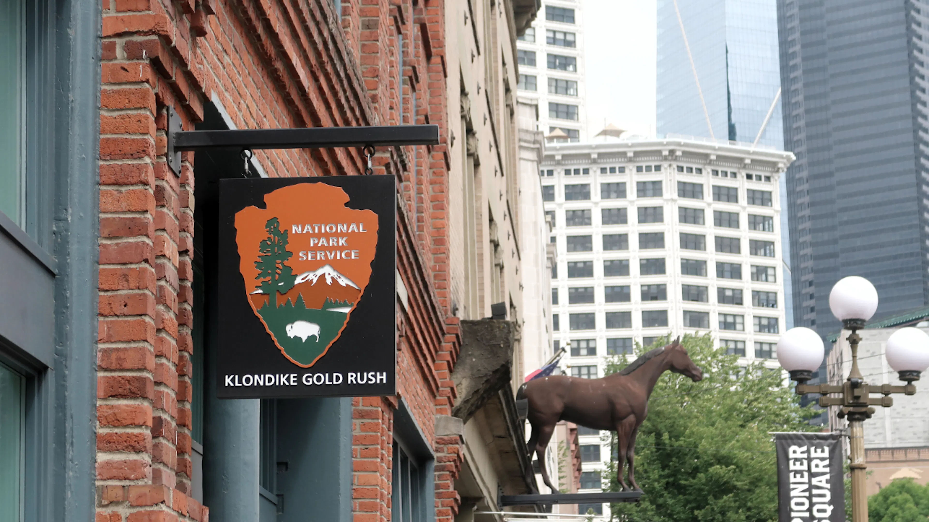 The exterior of the Klondike Gold Rush Museum focusing on the National Park Icon and sign