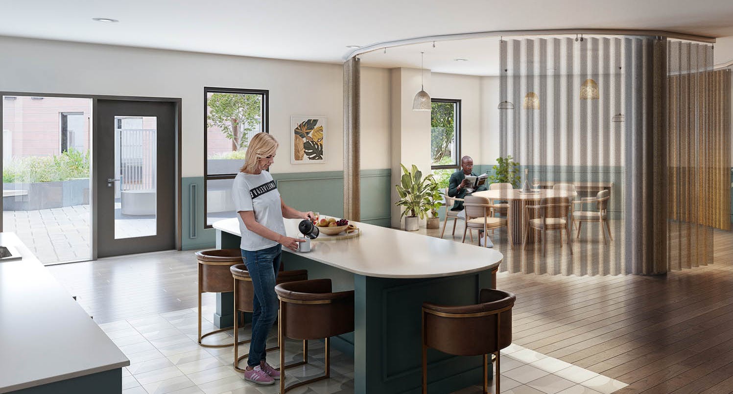 Coworking space at AMLI Redmond Way apartments with kitchen island, seating areas and large windows