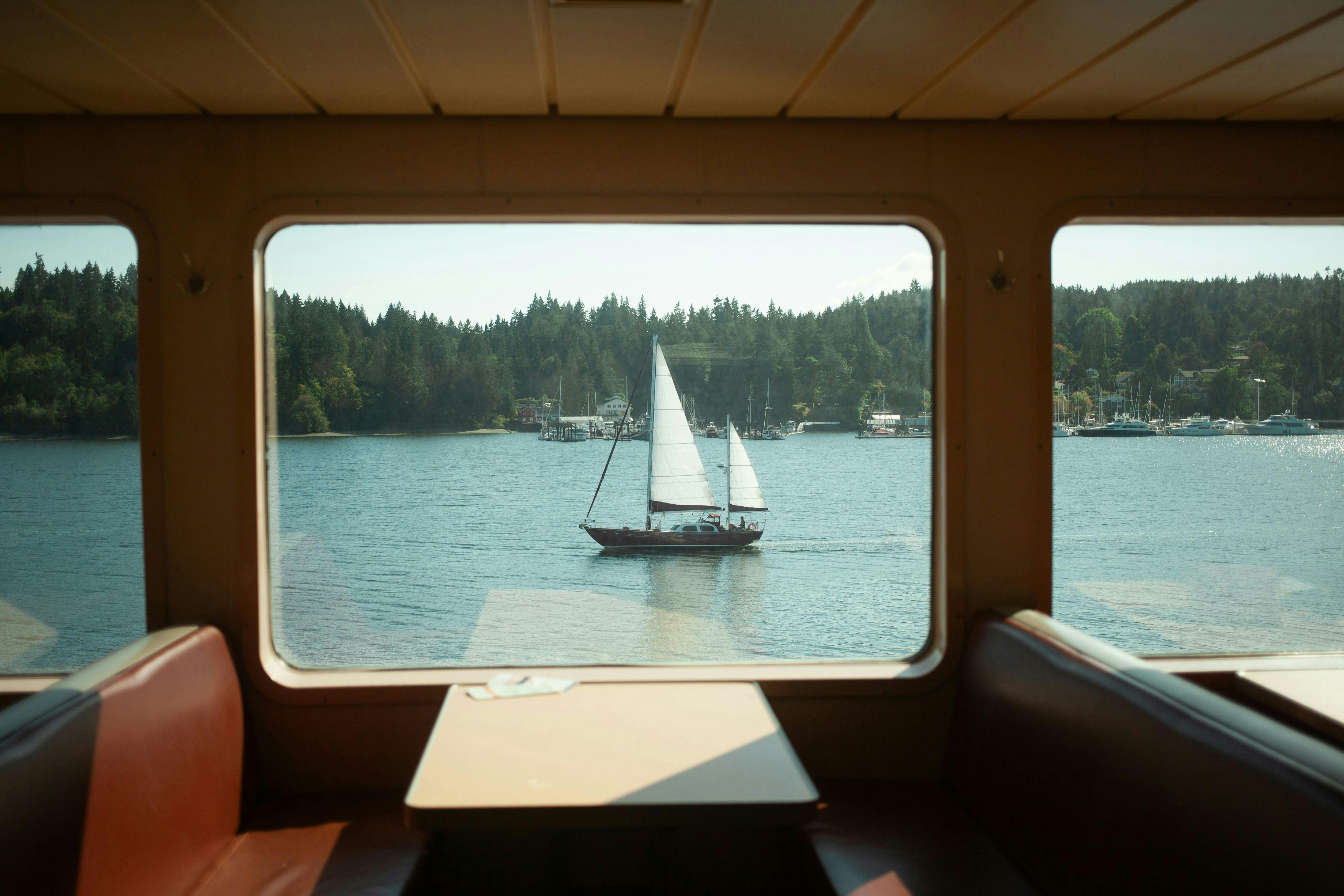 A sailboat seen from a ferry window in Puget Sound
