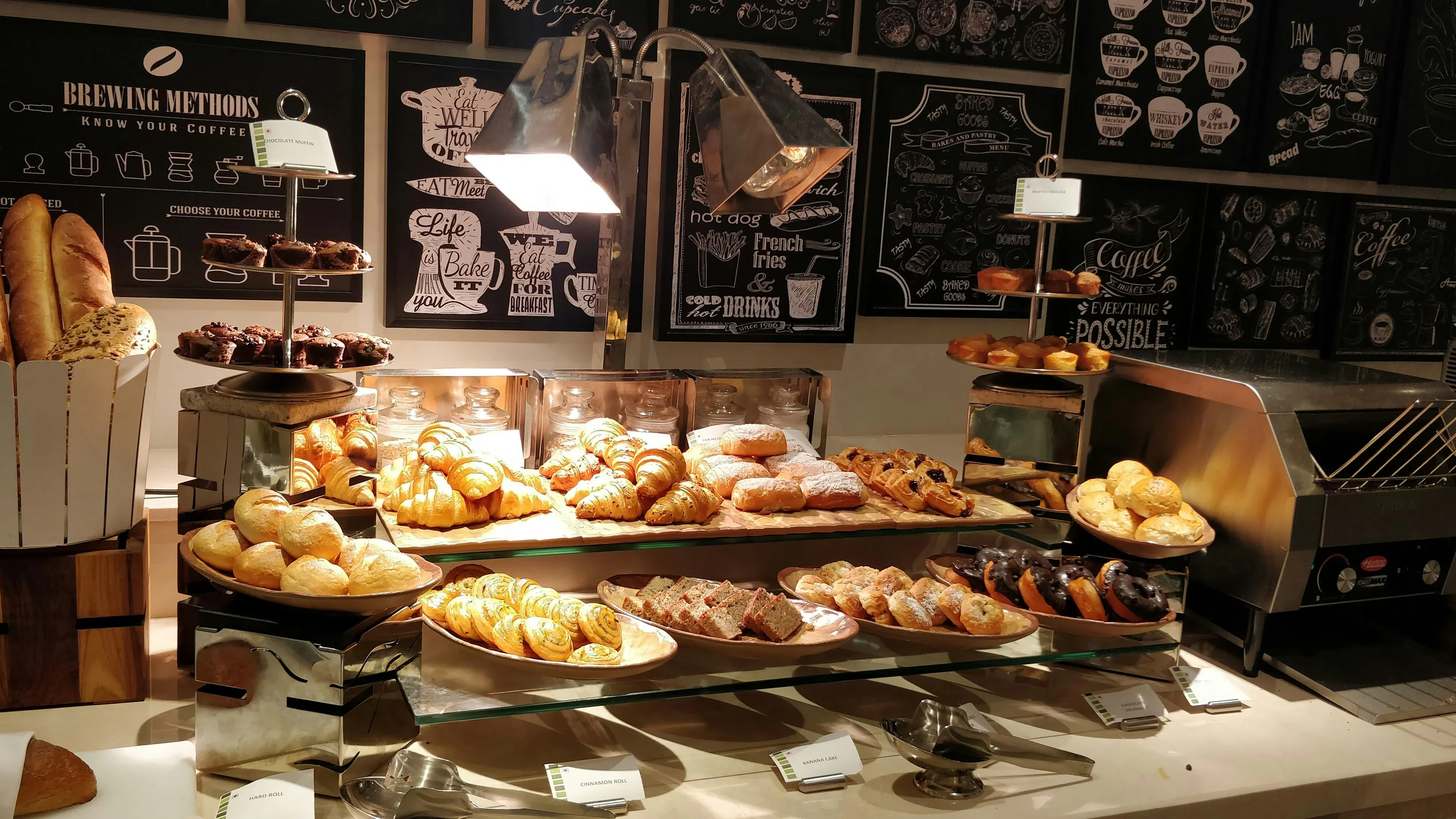 A three-level display shelf filled with pastries and breads