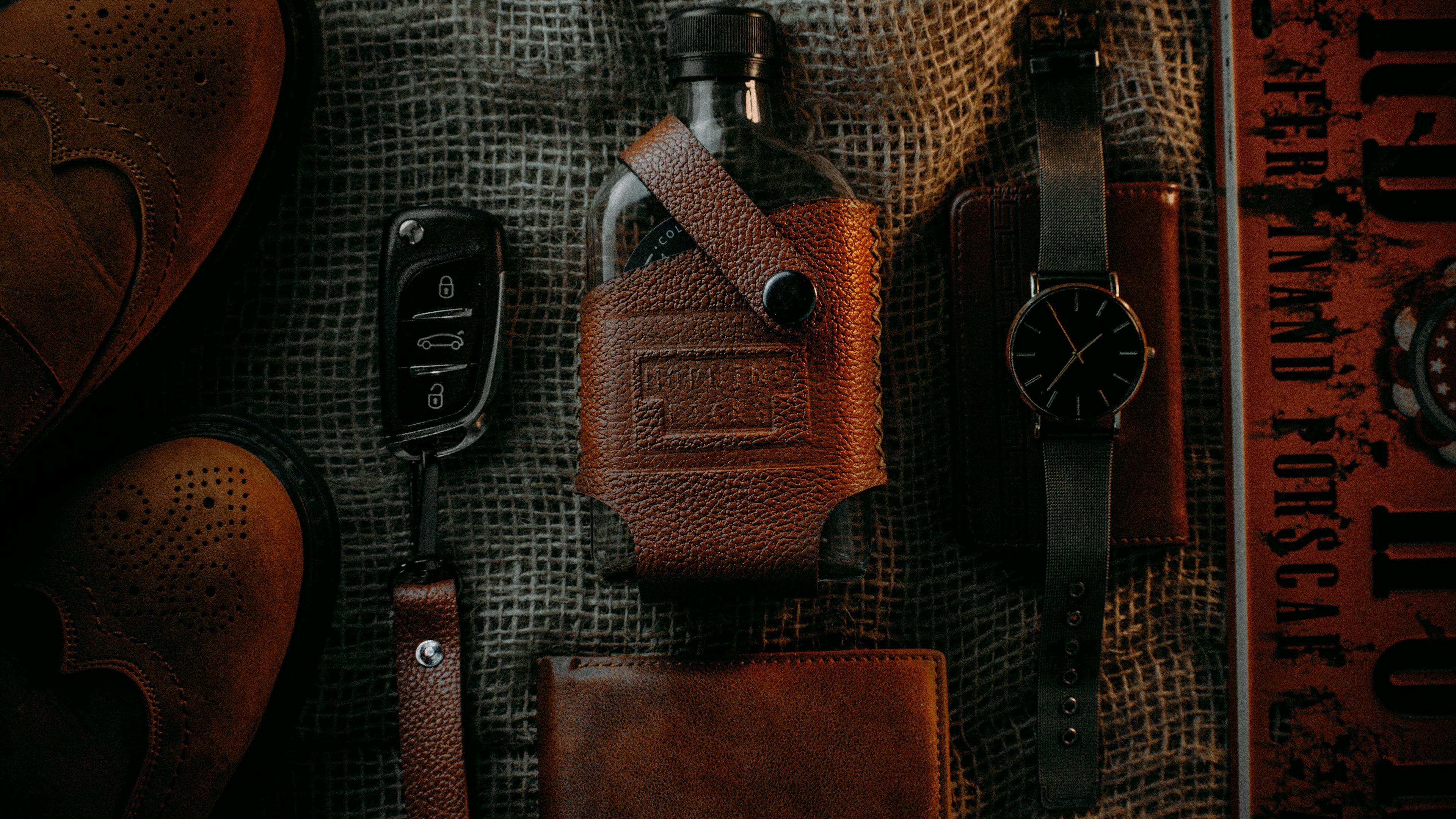 A flask cover and keychain made from leather goods