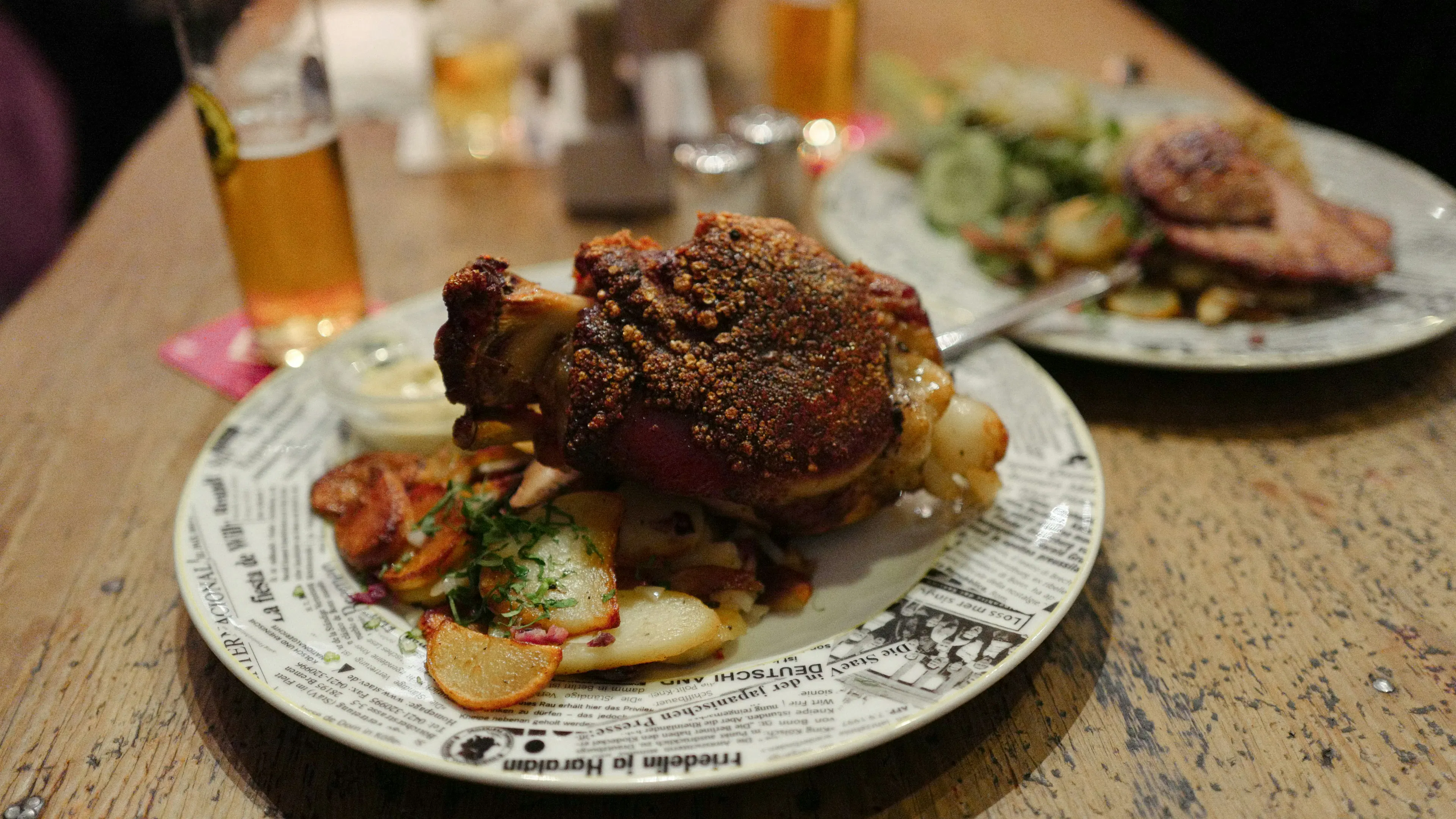 A PLATE OF PORK KNUCKLE WITH BEER