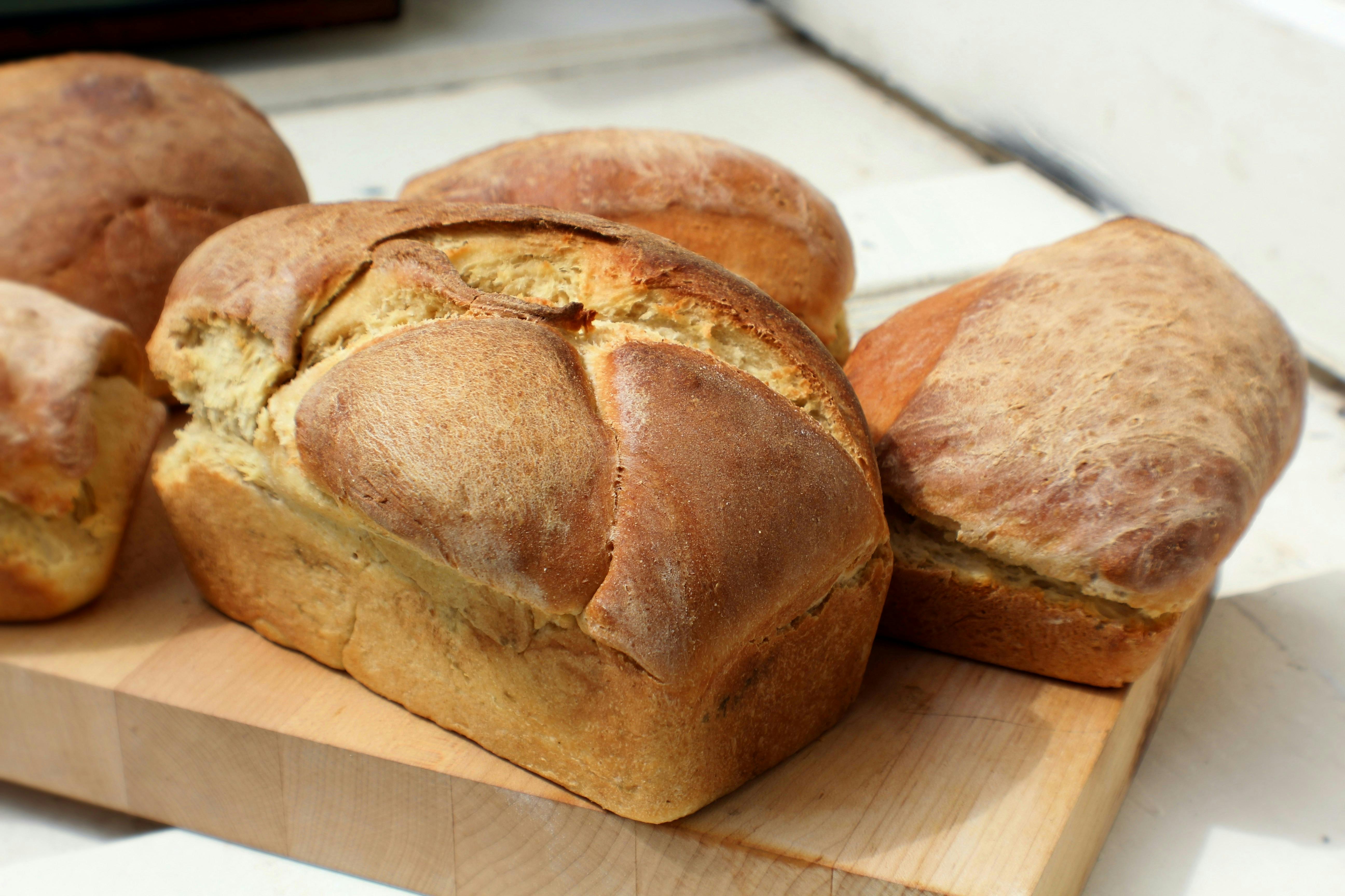 A loaf of plain bread on a wooden tray