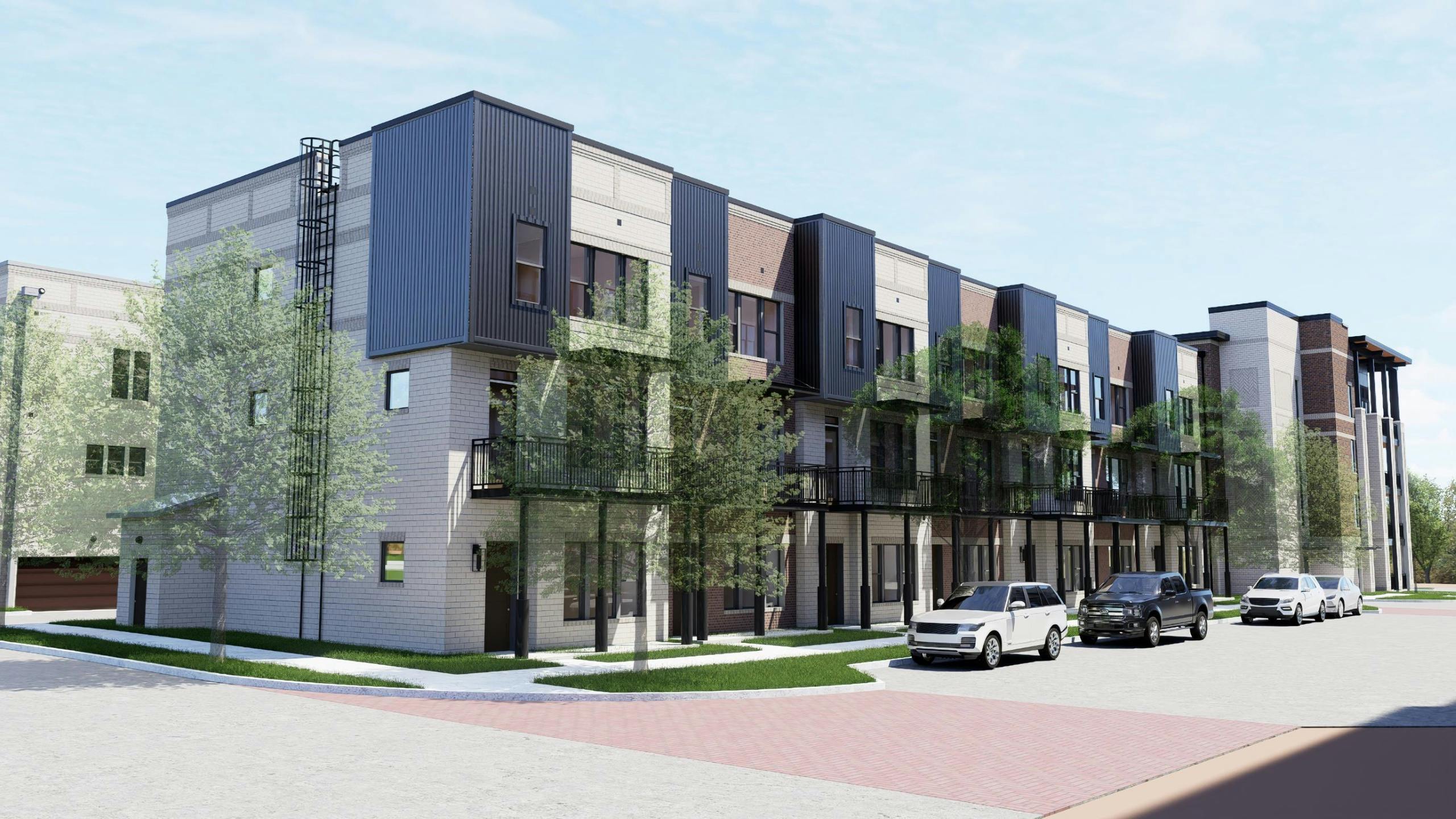 Outside view of a two-story white brick townhome building at AMLI Treehouse on a sunny day with grass and trees and plants