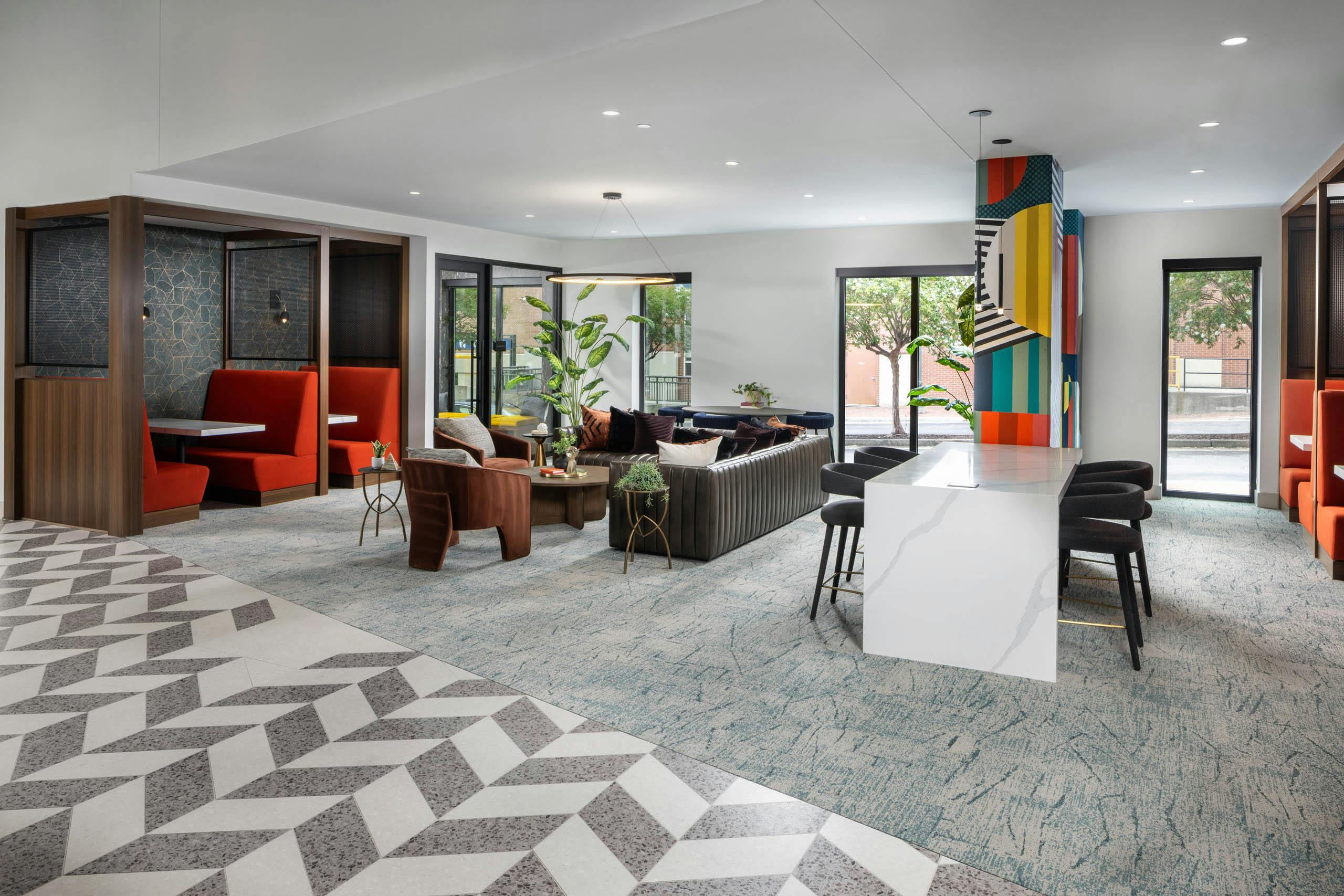 Coworking space at AMLI Atlantic Station with a bar top booths and seating.