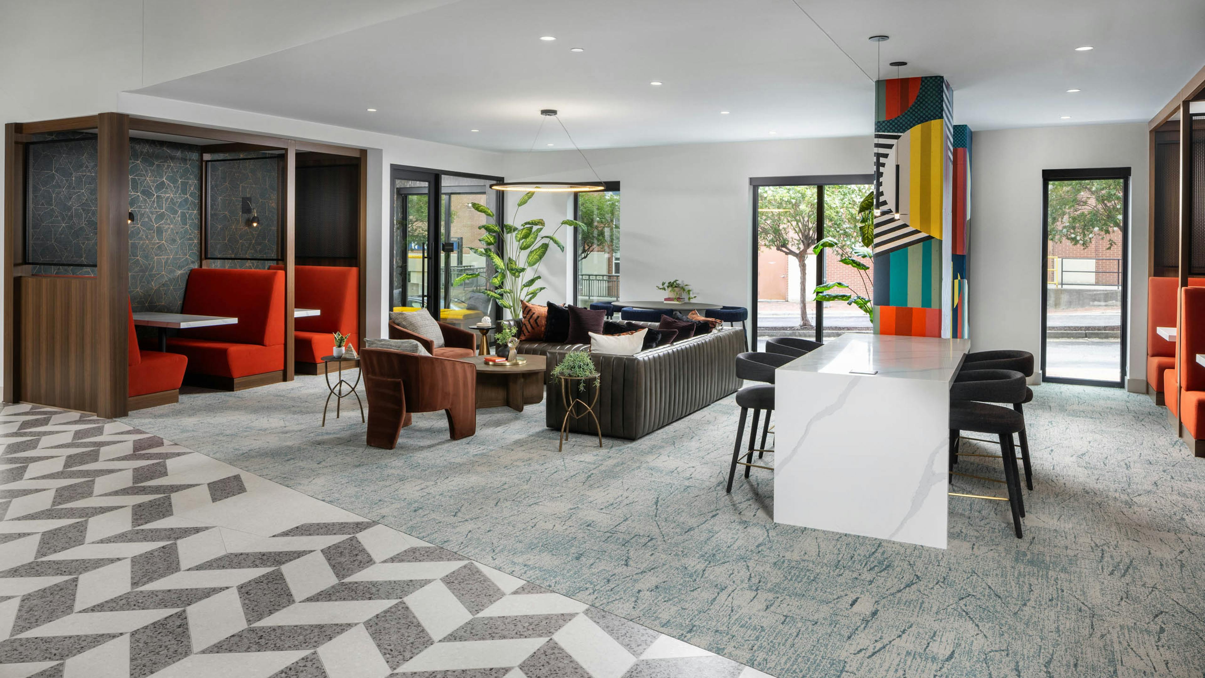 Coworking space at AMLI Atlantic Station with a bar top booths and seating.