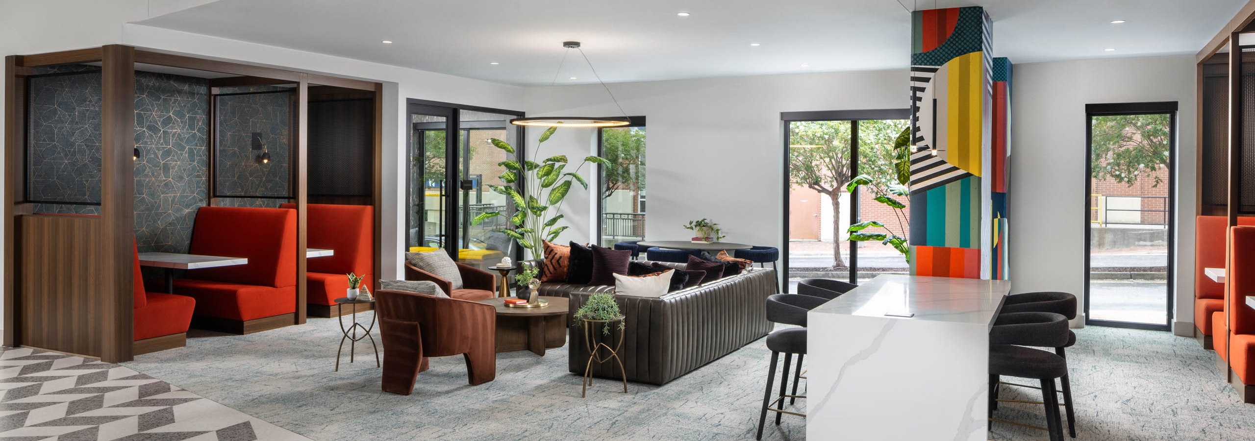Coworking space at AMLI Atlantic Station with a bar top booths and seating.