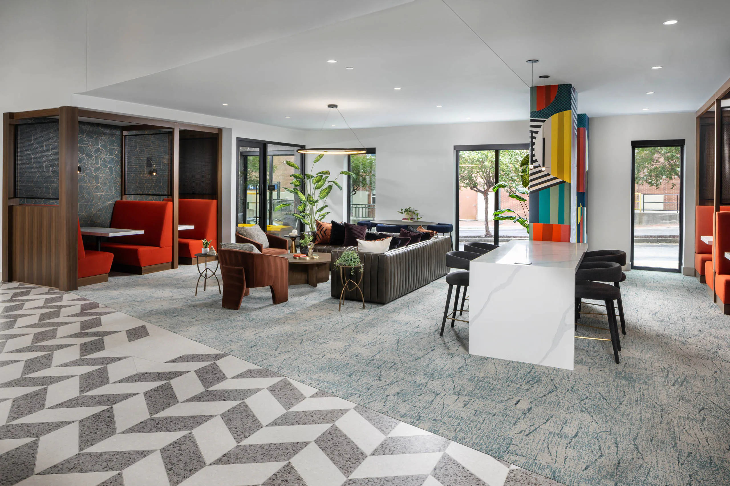 Coworking space at AMLI Atlantic Station with a bar top booths and seating.