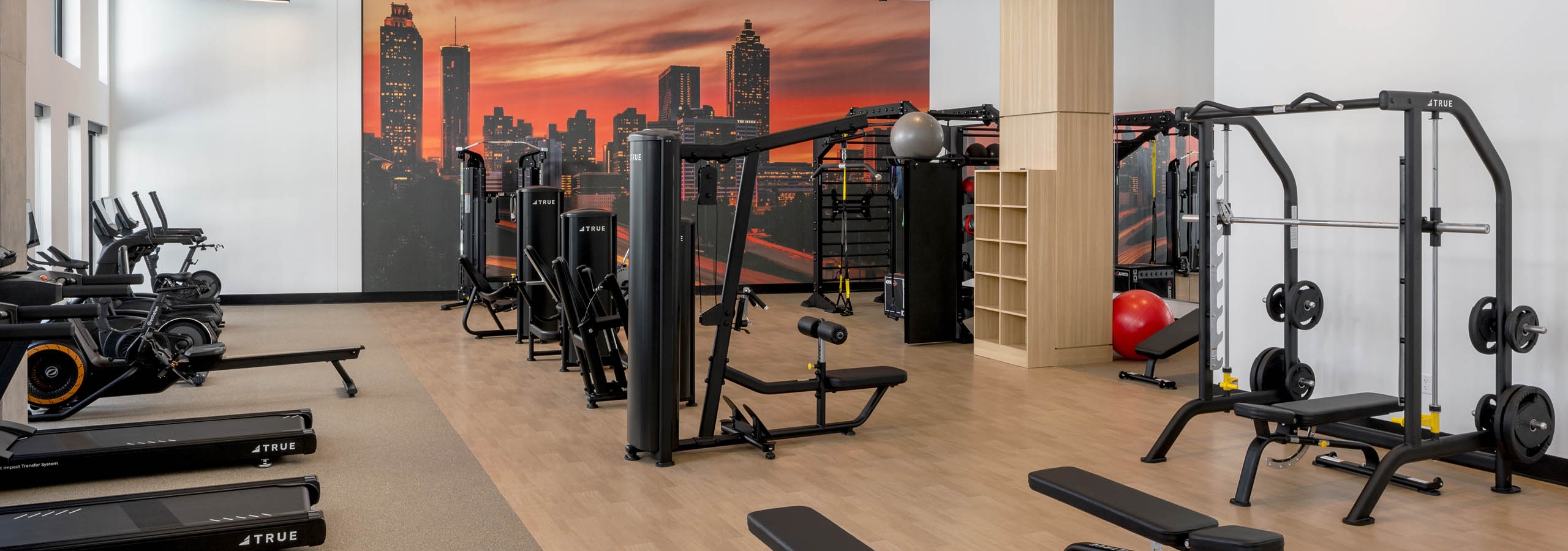 Fitness center at AMLI Atlantic Station with benches and equipment.