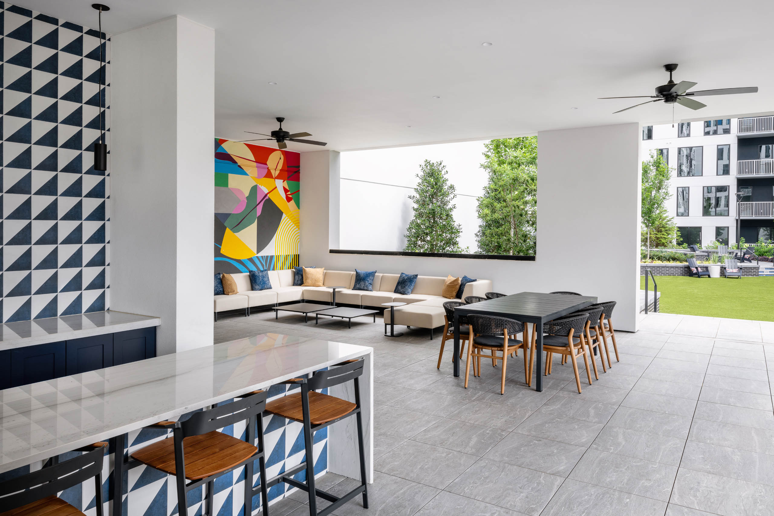 Outdoor kitchen with fans and lounge seating in AMLI Atlantic Station courtyard.