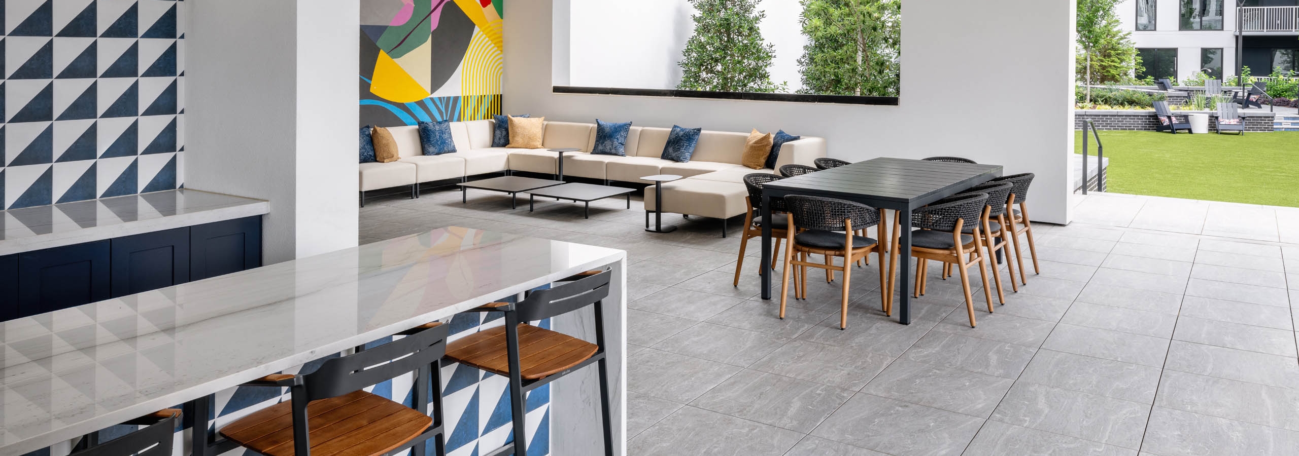 Outdoor kitchen with fans and lounge seating in AMLI Atlantic Station courtyard.
