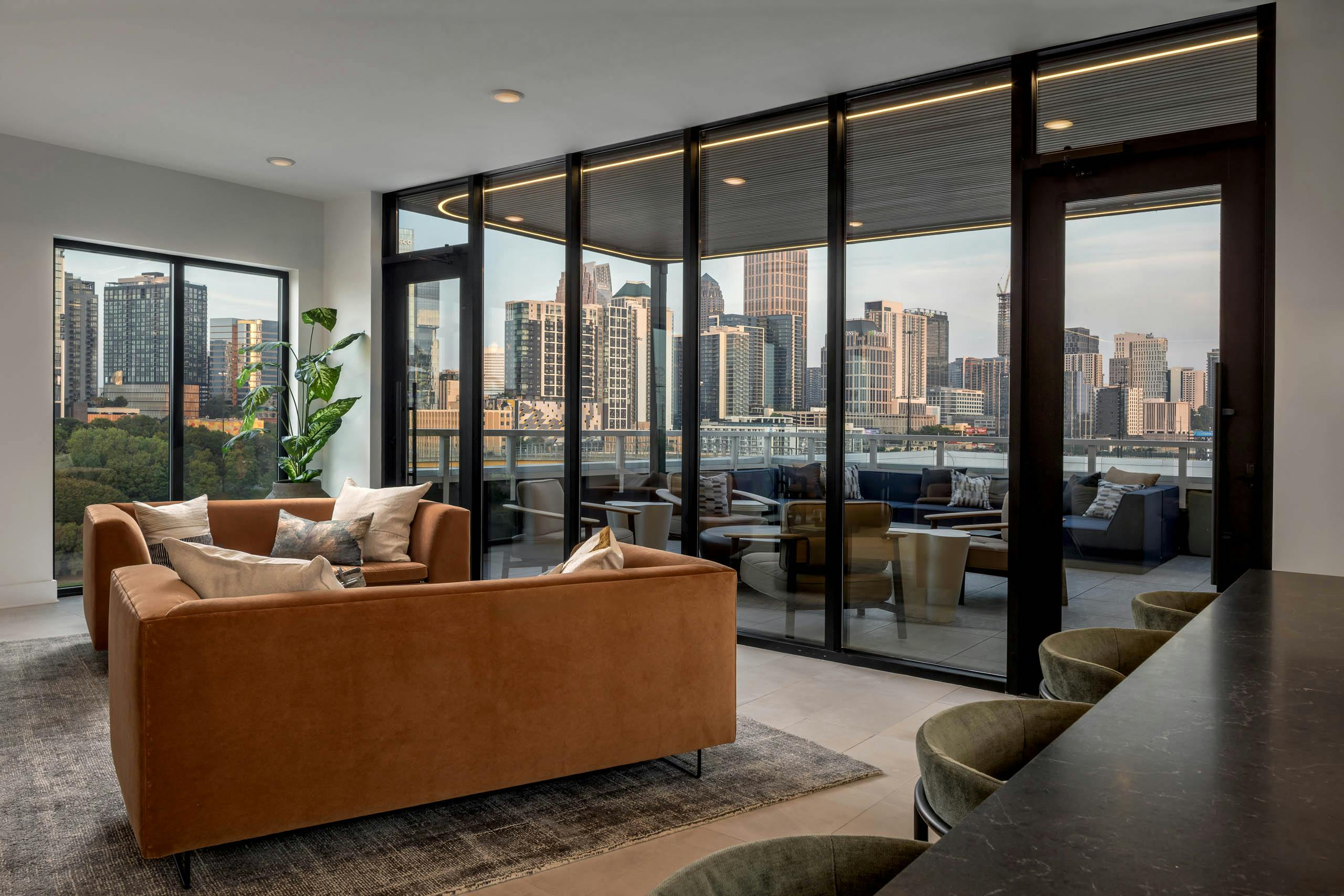 Lounge and rooftop patio at AMLI Atlantic Station with couch and bar seating.