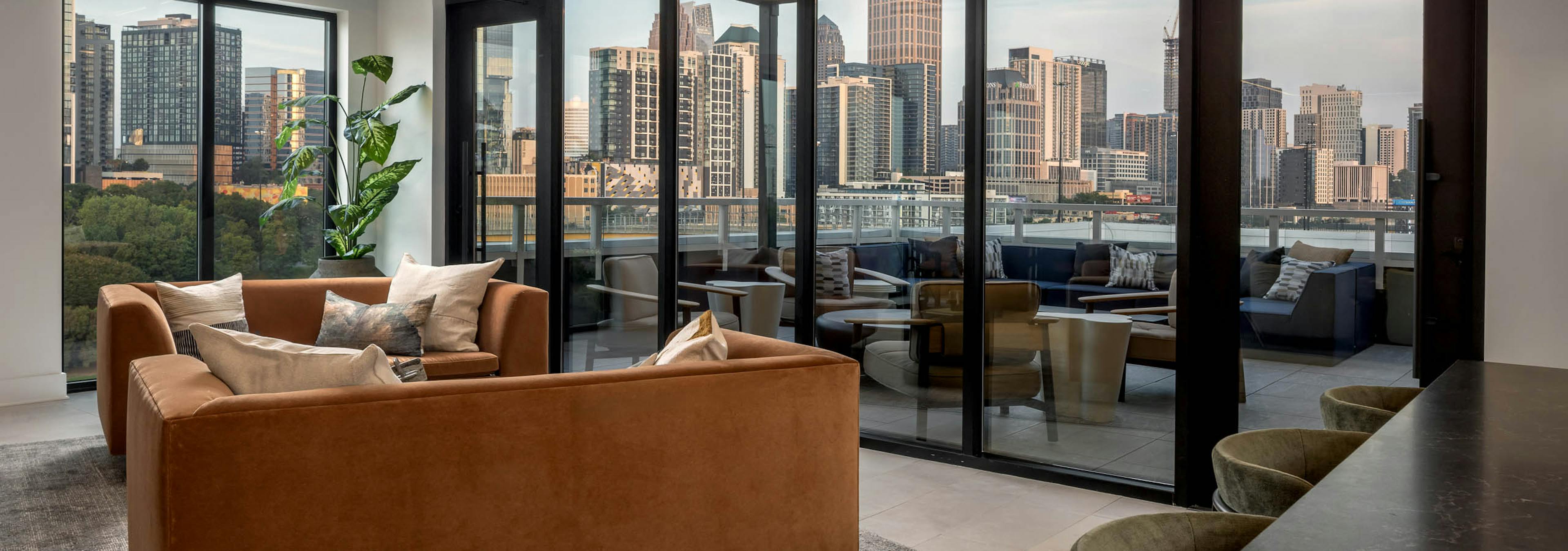Lounge and rooftop patio at AMLI Atlantic Station with couch and bar seating.