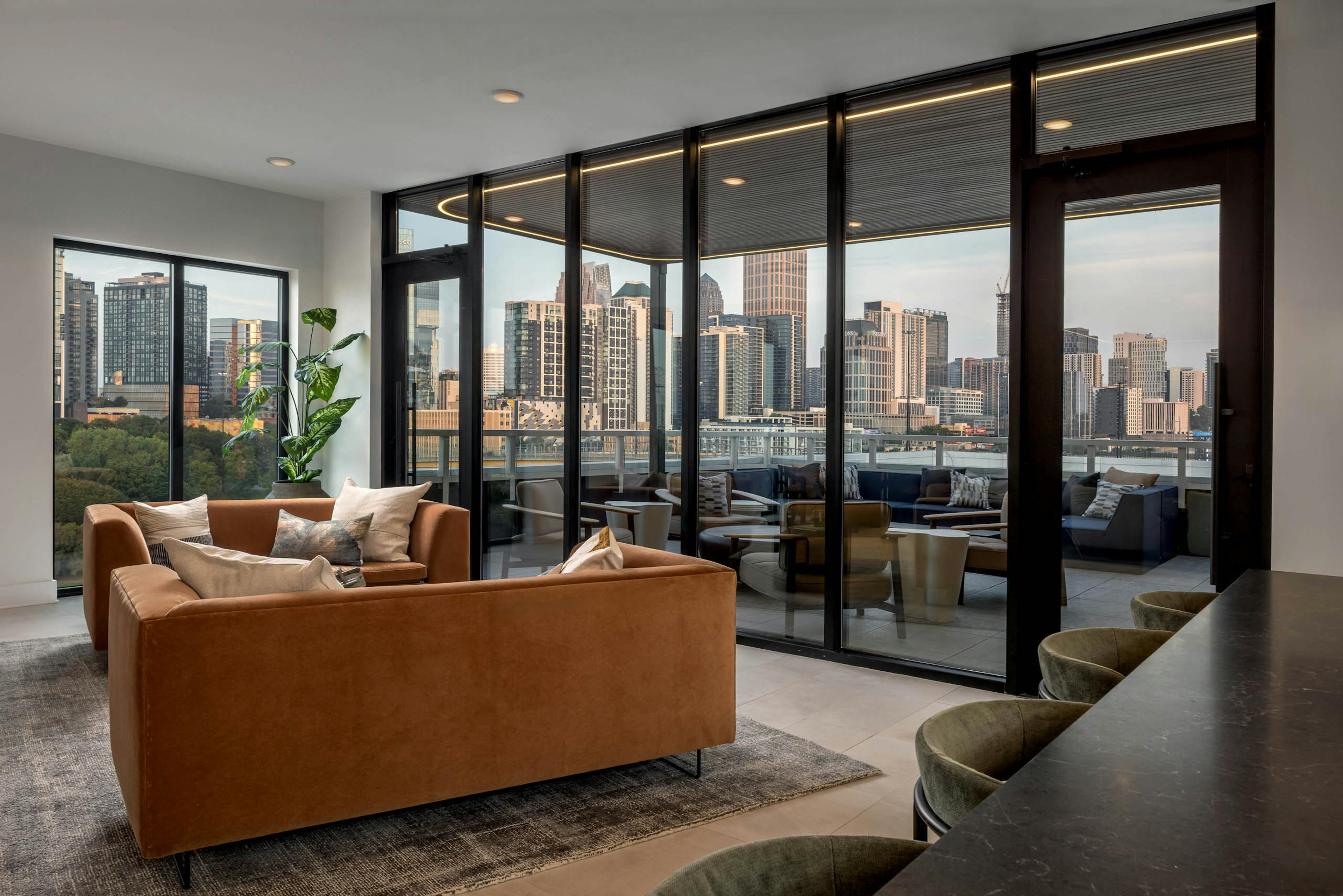 Lounge and rooftop patio at AMLI Atlantic Station with couch and bar seating.