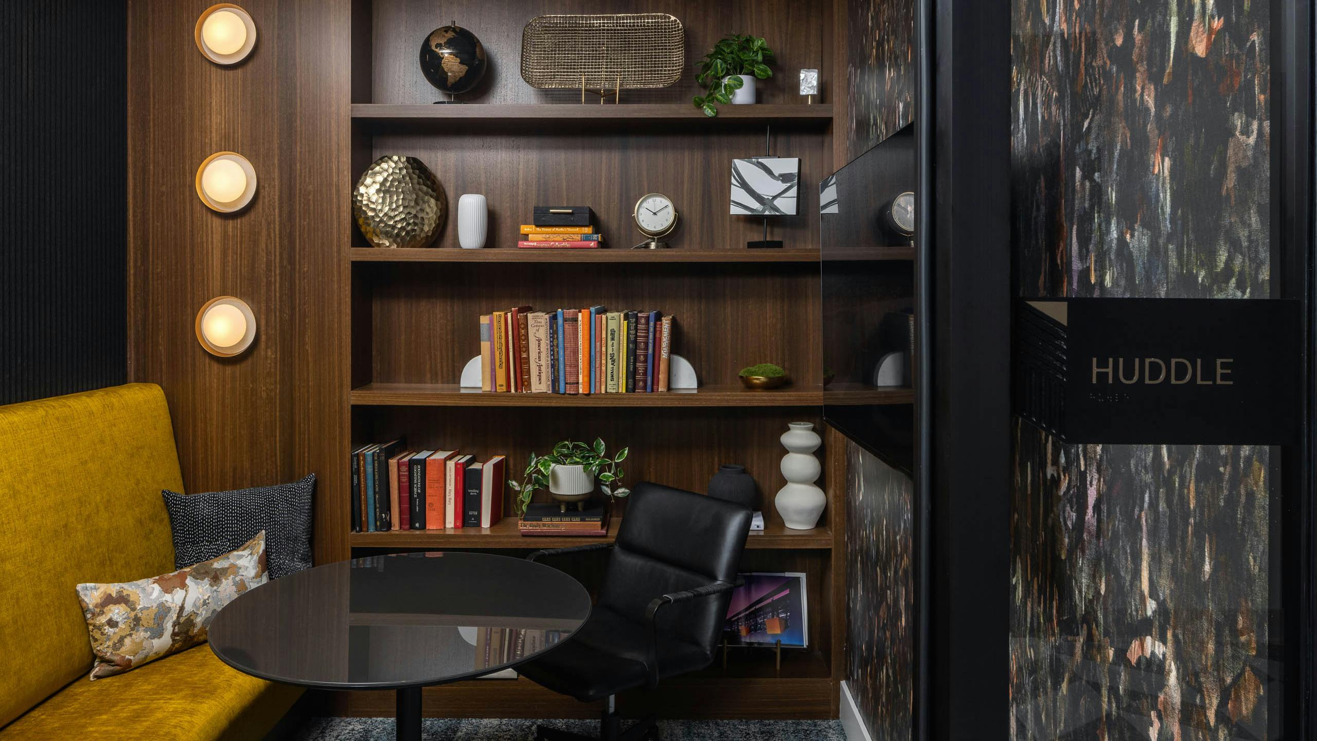 Library room labeled Huddle with a bench and built in shelves at AMLI Atlantic Station.