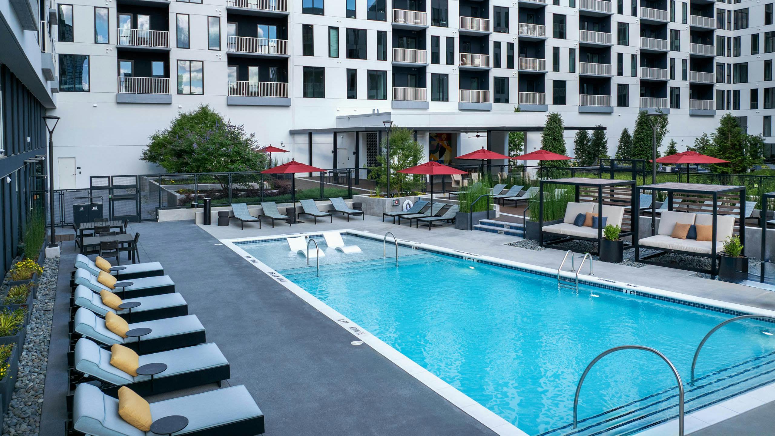AMLI Atlantic Station swimming pool and courtyard with lounge seating and cabanas.
