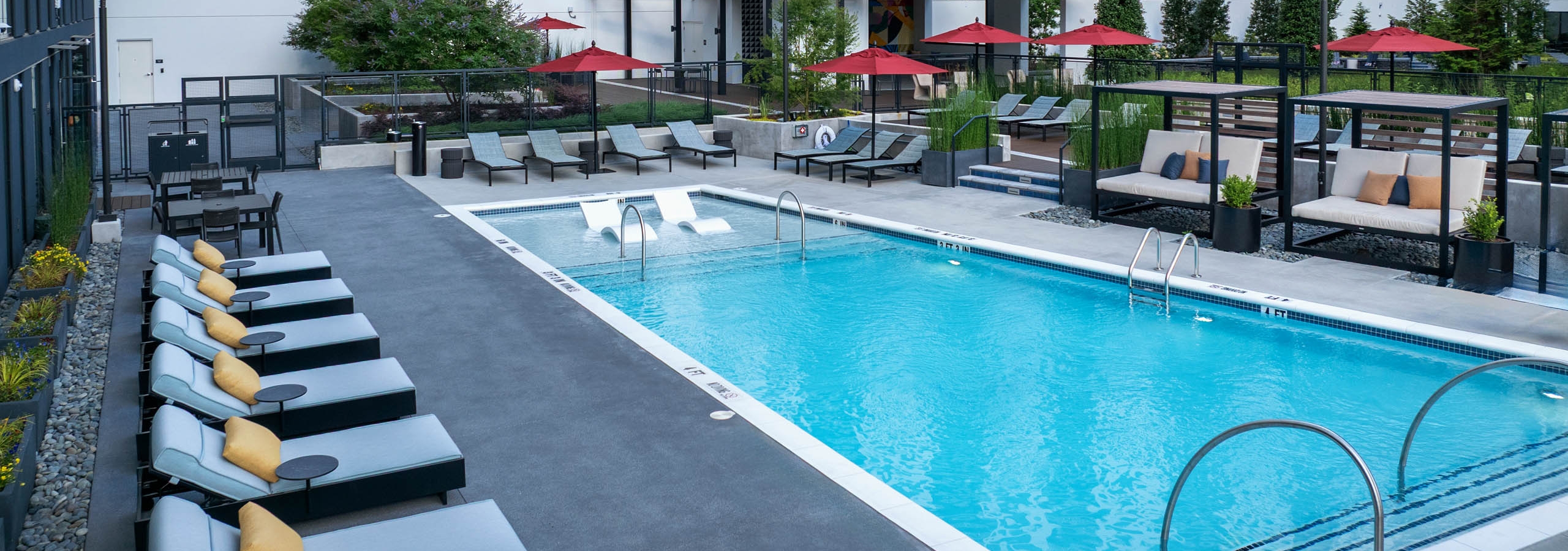AMLI Atlantic Station swimming pool and courtyard with lounge seating and cabanas.