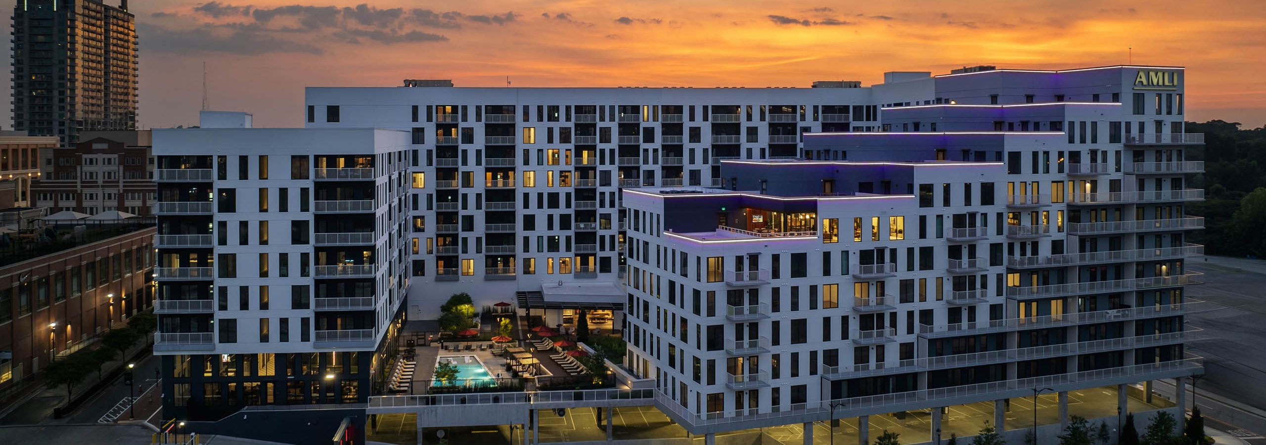 Exterior sunset view of balconies and pool courtyard at AMLI Atlantic Station.