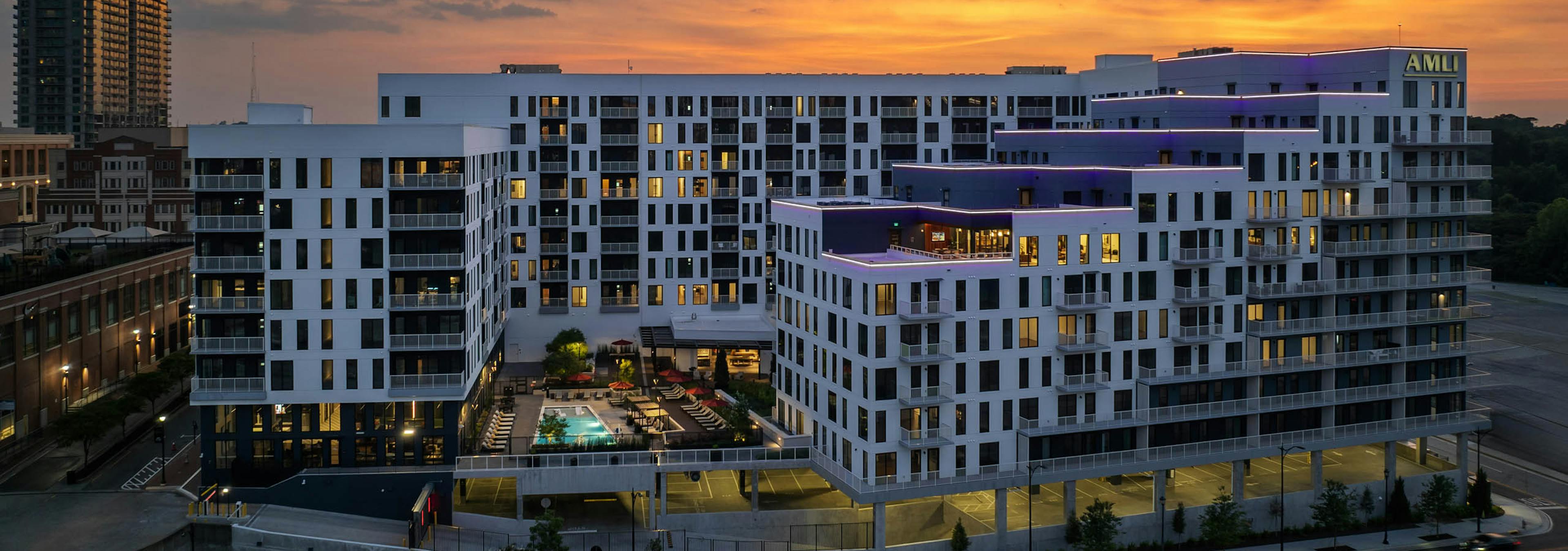 Exterior sunset view of balconies and pool courtyard at AMLI Atlantic Station.