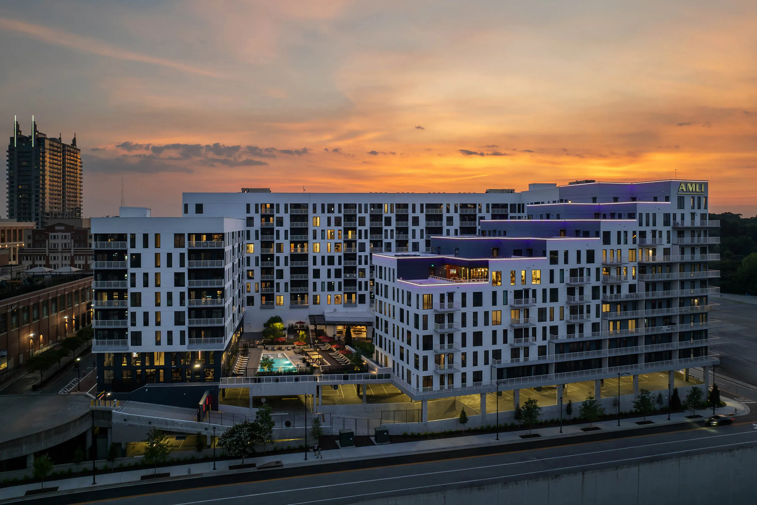 Exterior sunset view of balconies and pool courtyard at AMLI Atlantic Station.
