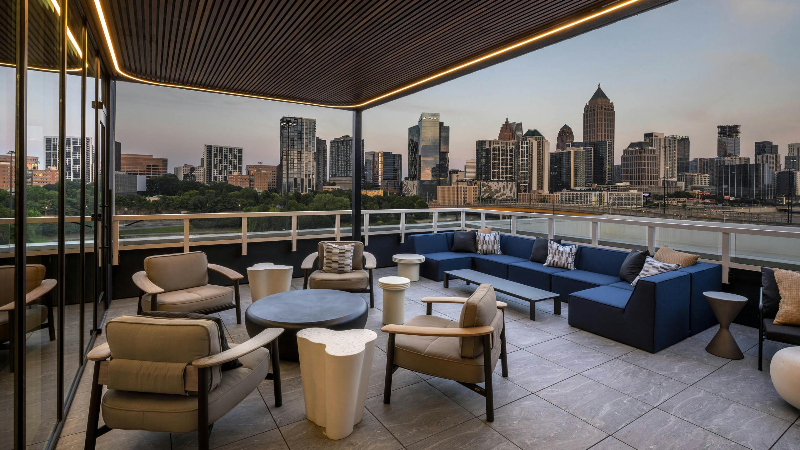 Rooftop patio at AMLI Atlantic Station with assorted seating and view of the city skyline.