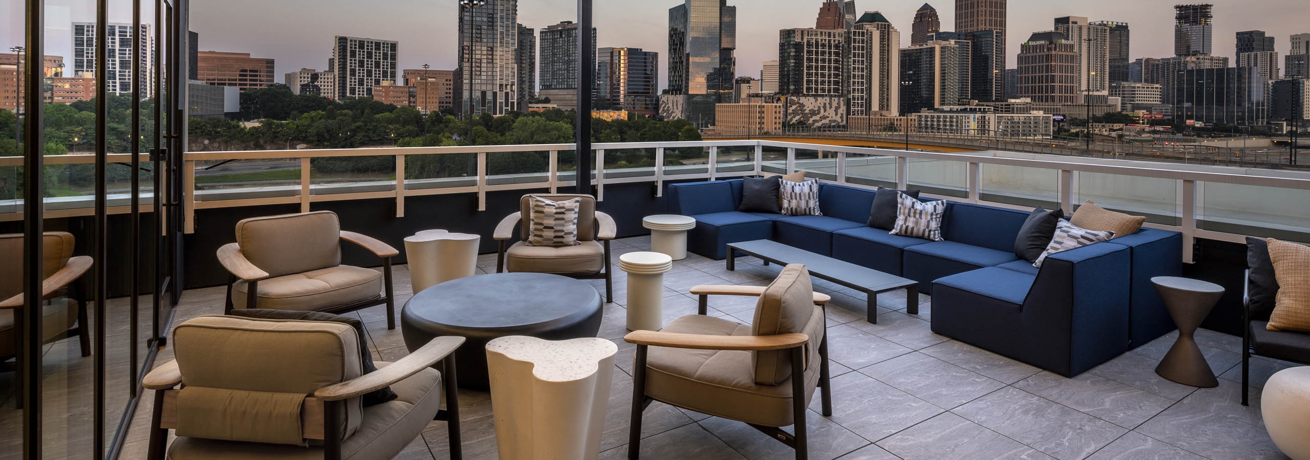 Rooftop patio at AMLI Atlantic Station with assorted seating and view of the city skyline.