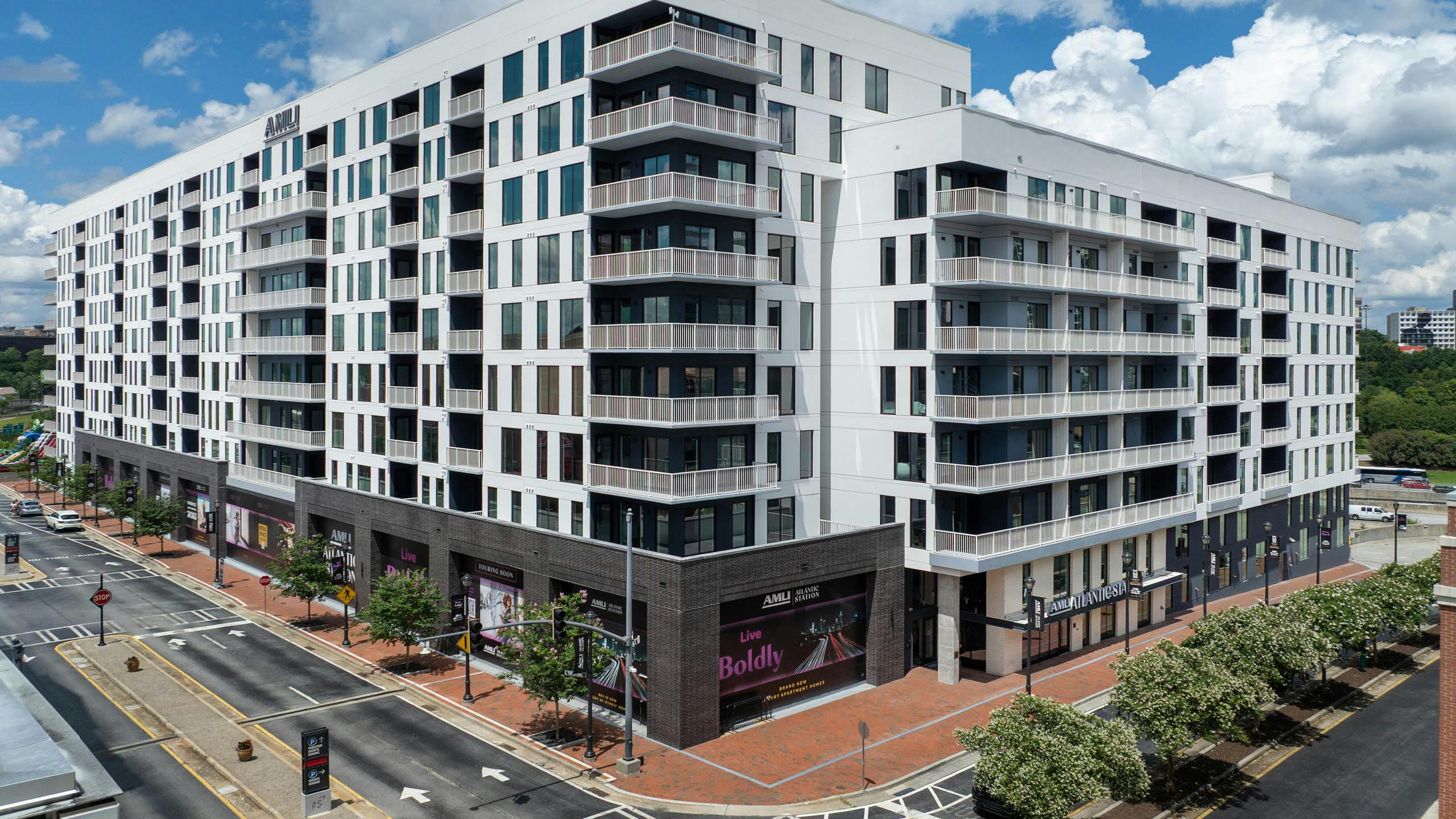 Corner view of building exterior and leasing office entrance at AMLI Atlantic Station.