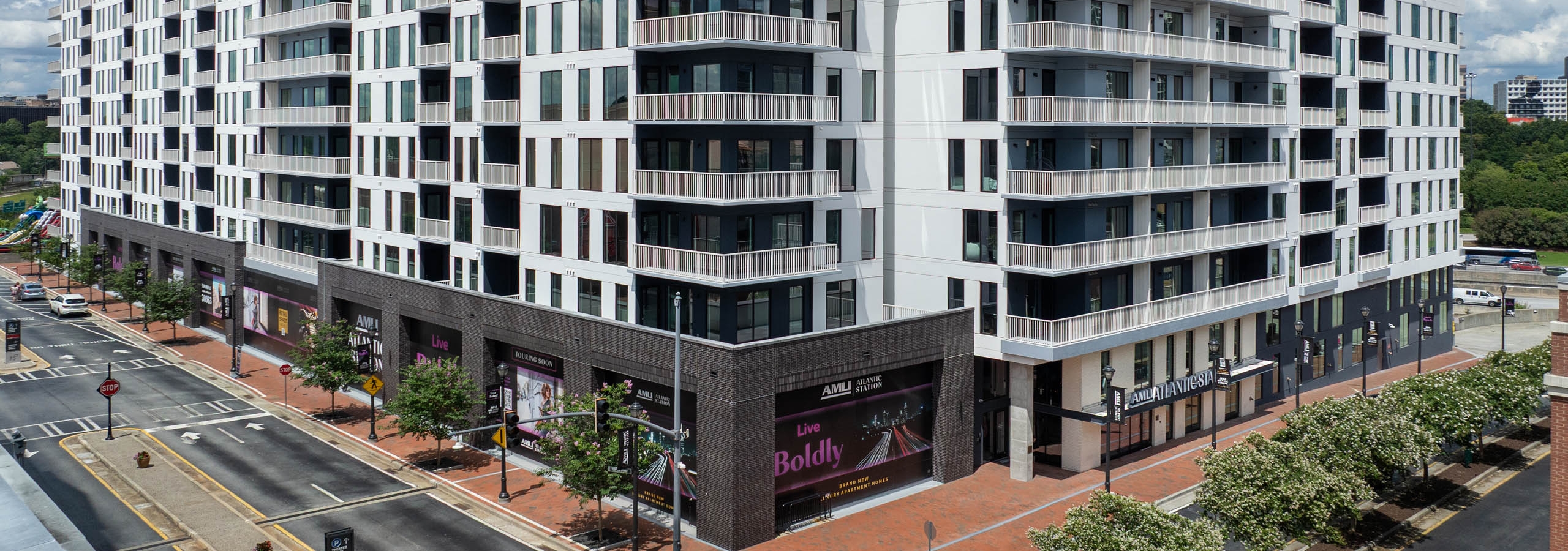 Corner view of building exterior and leasing office entrance at AMLI Atlantic Station.