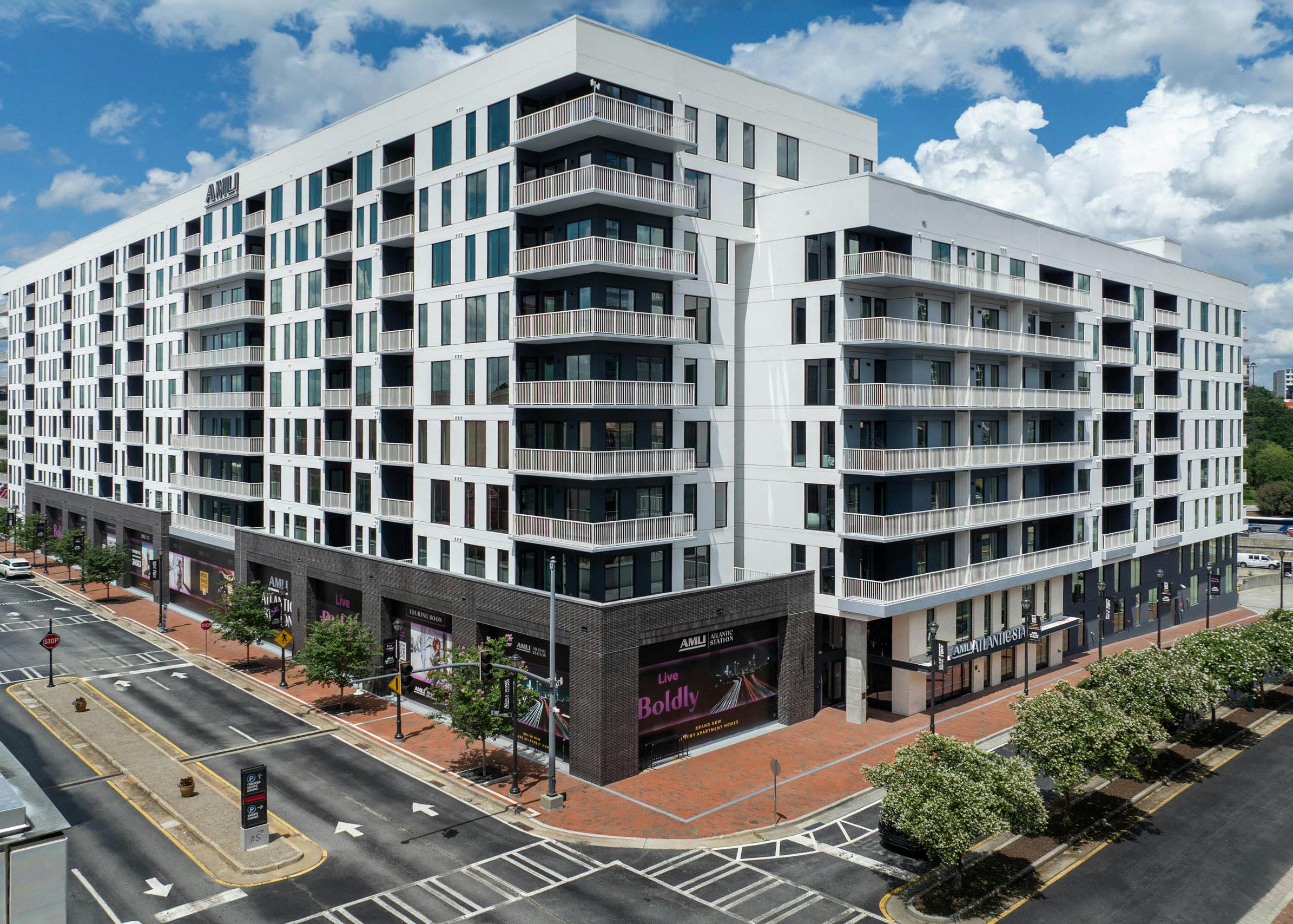 Corner view of building exterior and leasing office entrance at AMLI Atlantic Station.