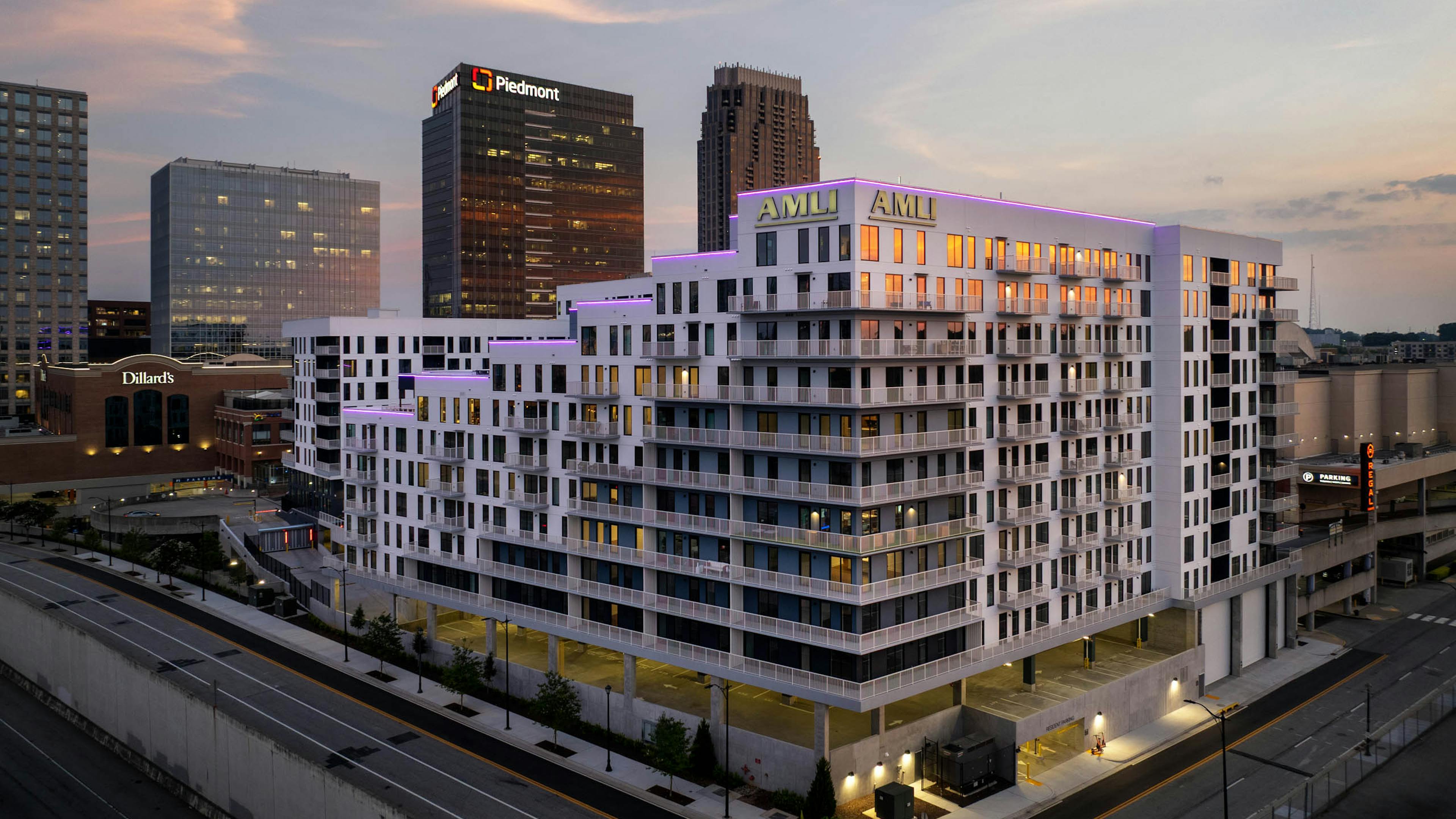 AMLI Atlantic Station exterior at sunset with balconies and street lighting.