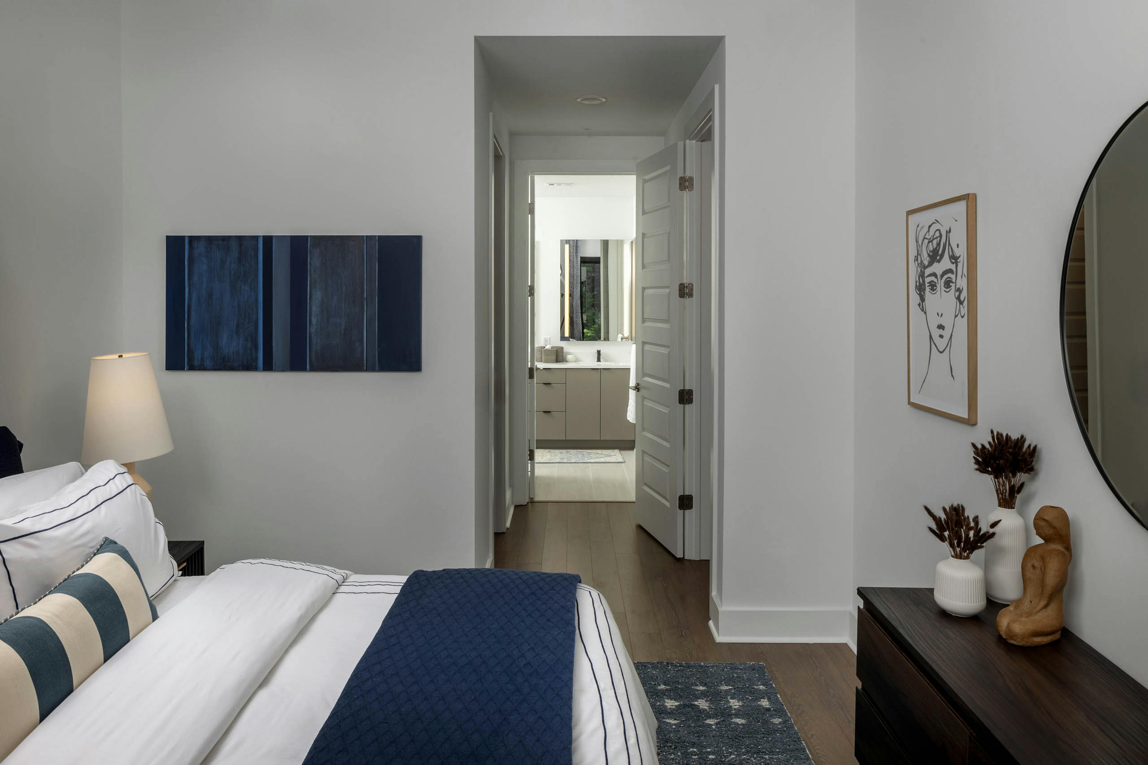 Bedroom and hallway at AMLI Atlantic Station connecting to a bathroom.