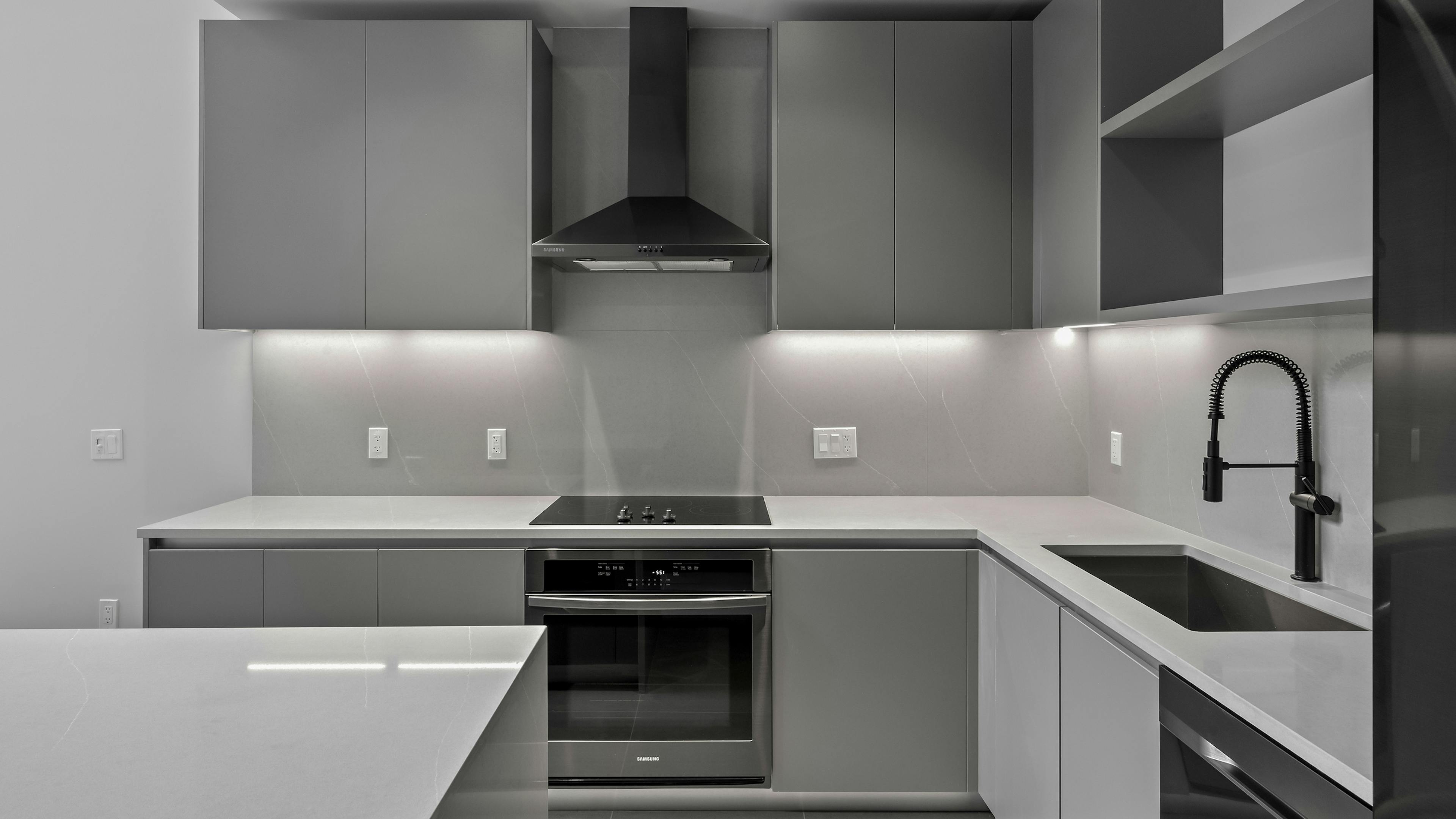 Modern kitchen at AMLI Wynwood with recessed lighting and stainless-steel appliances.