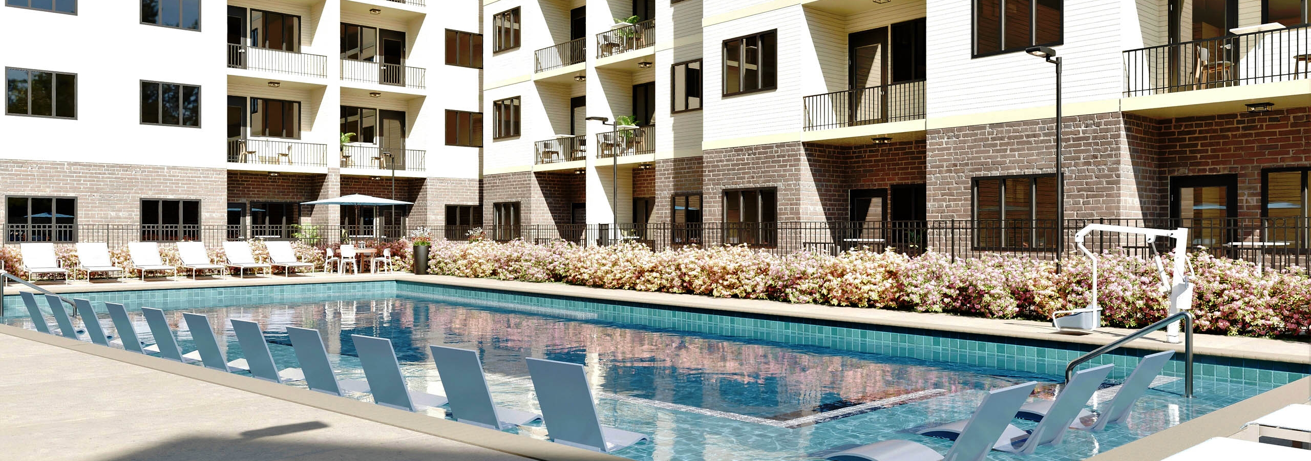 Apartment balconies facing swimming pool and lounge chairs at AMLI Brookhaven.