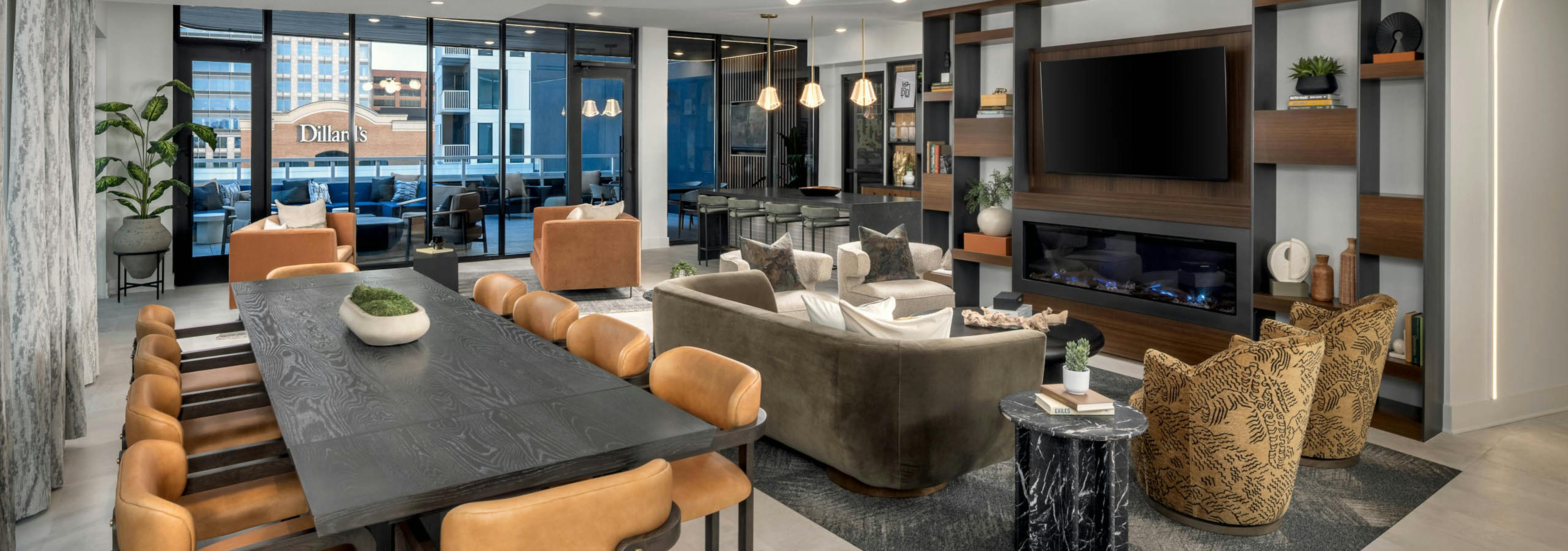 Lounge with large table and seating around a mounted television at AMLI Atlantic Station.