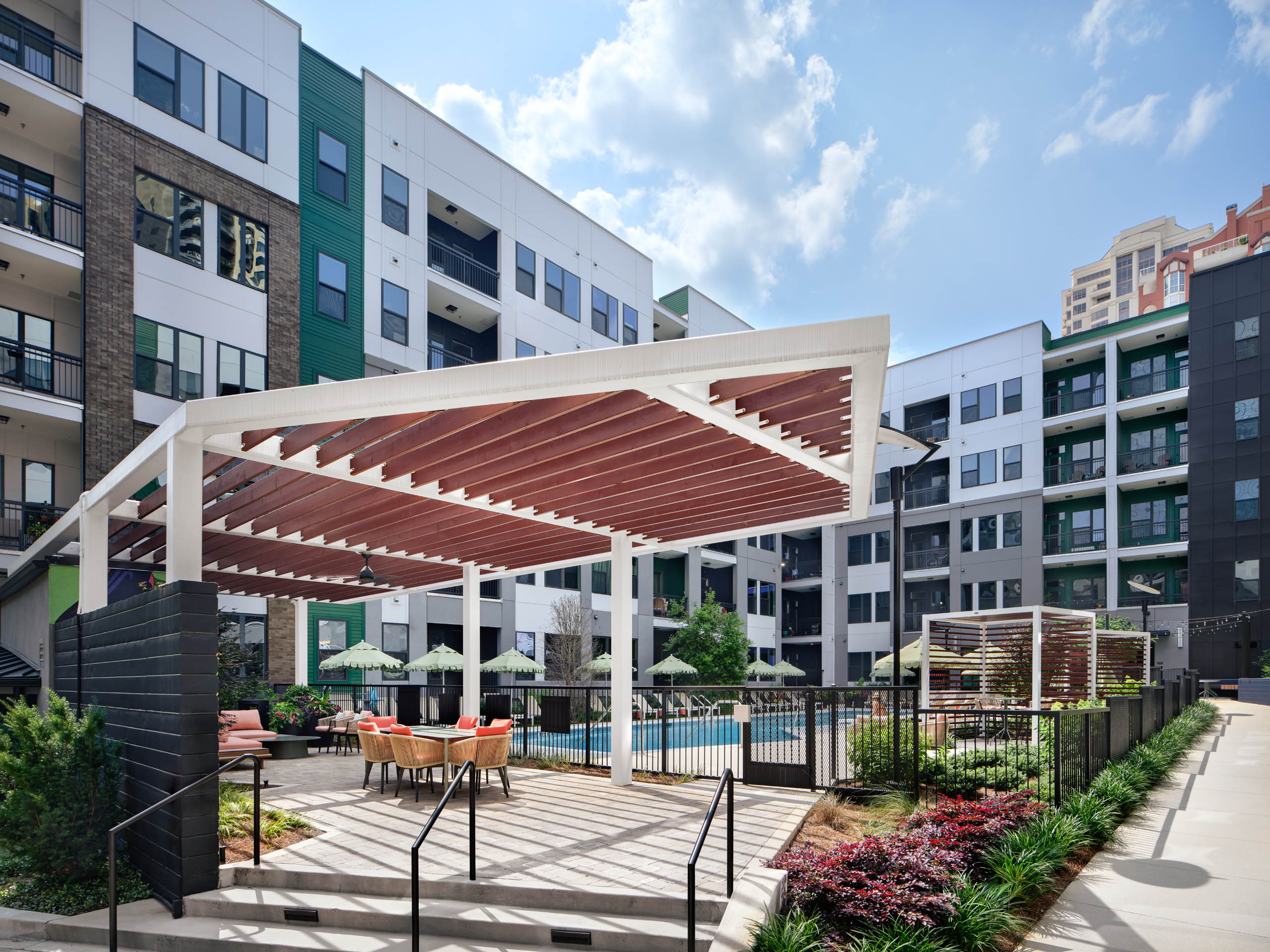 Shade structures at AMLI Flatiron next to swimming pool and lounge chairs.