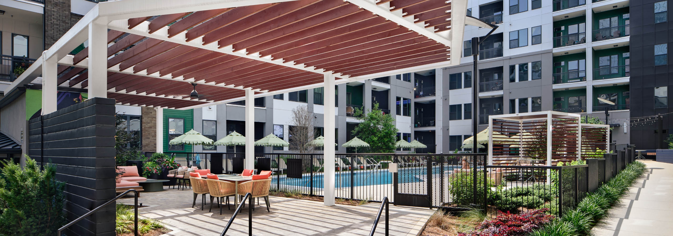Shade structures at AMLI Flatiron next to swimming pool and lounge chairs.