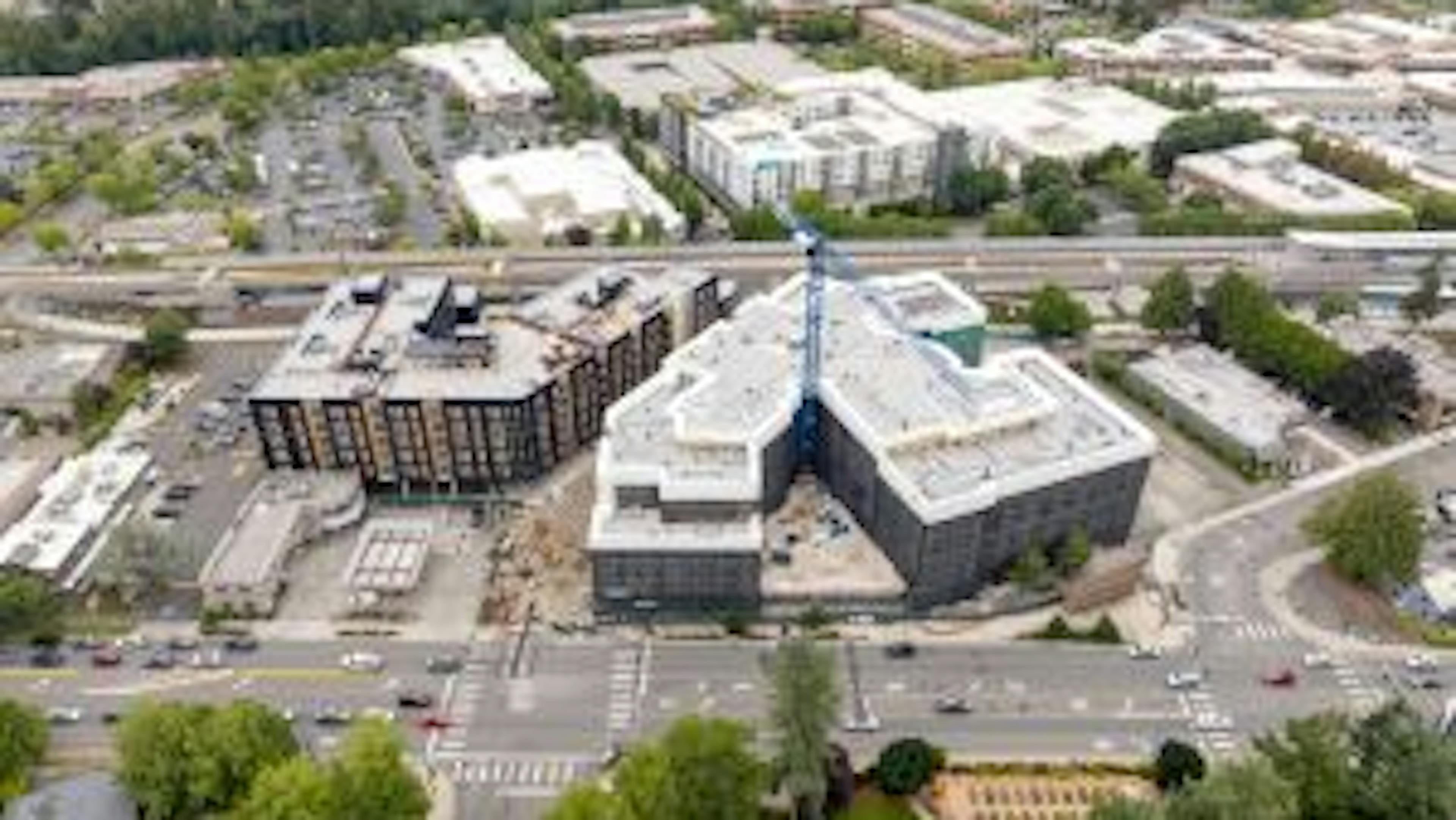 Aerial photo of construction at AMLI Redmond Way apartments with a large crane and siding being installed
