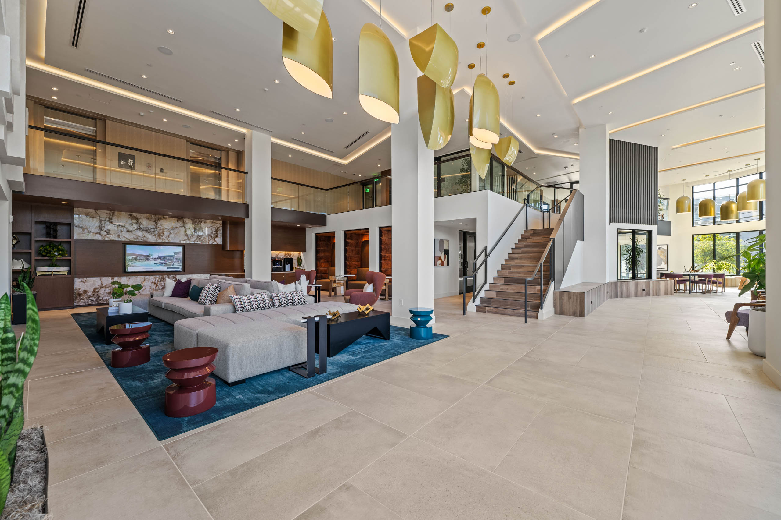 Large open lobby at AMLI Aero with staircase and second floor overlooking the first and modern design.