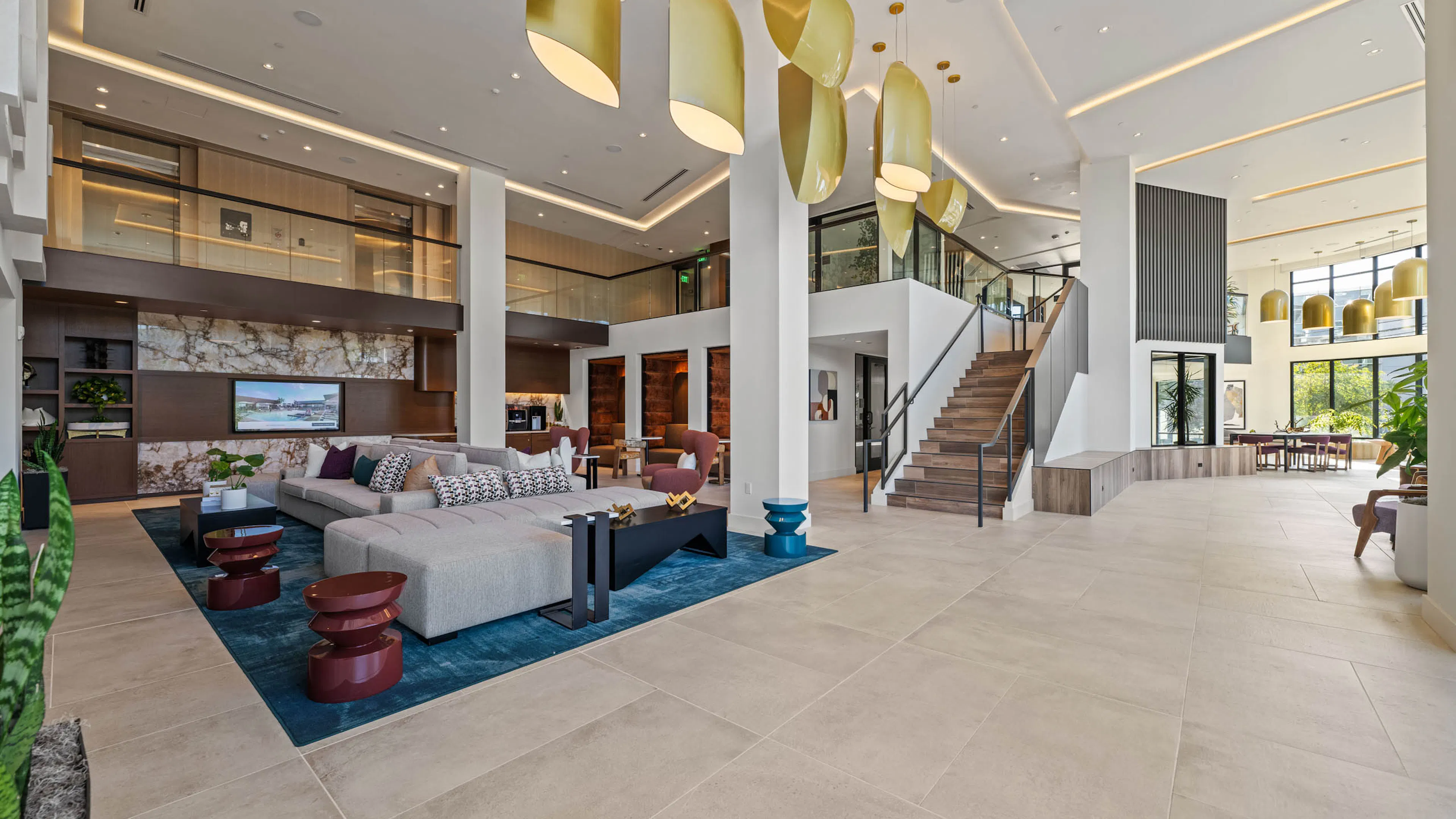 Large open lobby at AMLI Aero with staircase and second floor overlooking the first and modern design.
