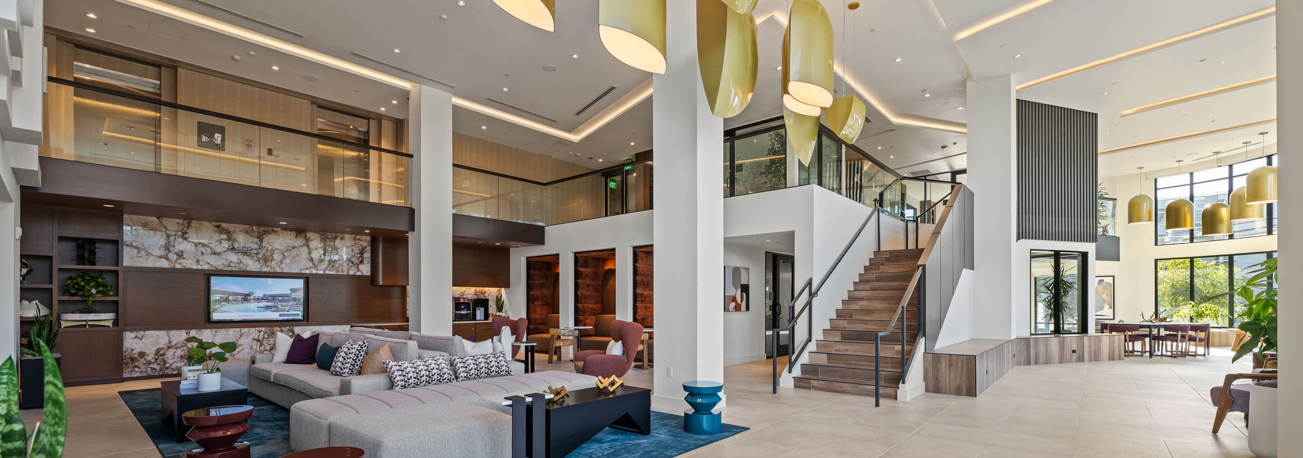 Large open lobby at AMLI Aero with staircase and second floor overlooking the first and modern design.