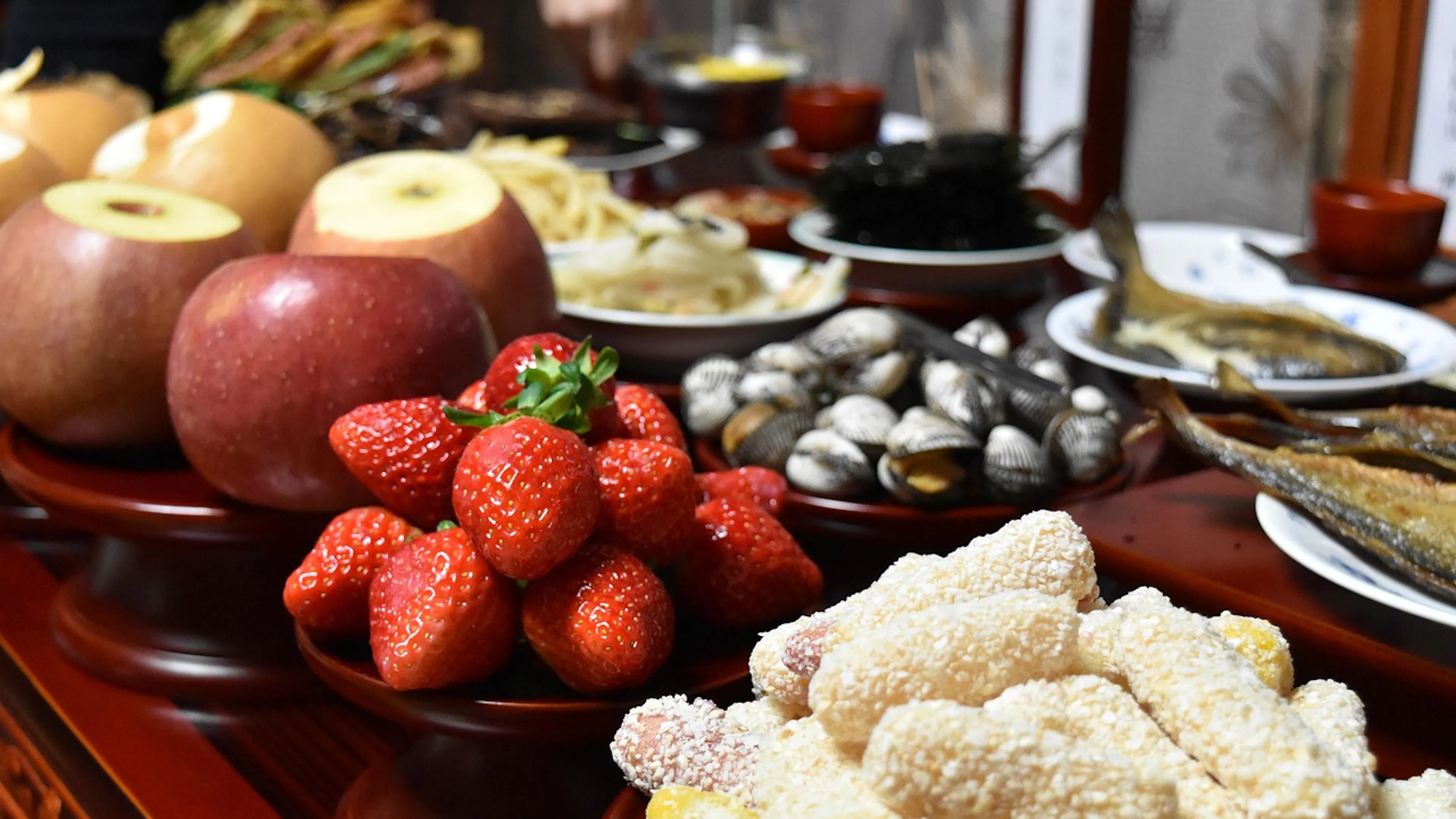 table with cookies, apples, strawberries, nuts and appetizers